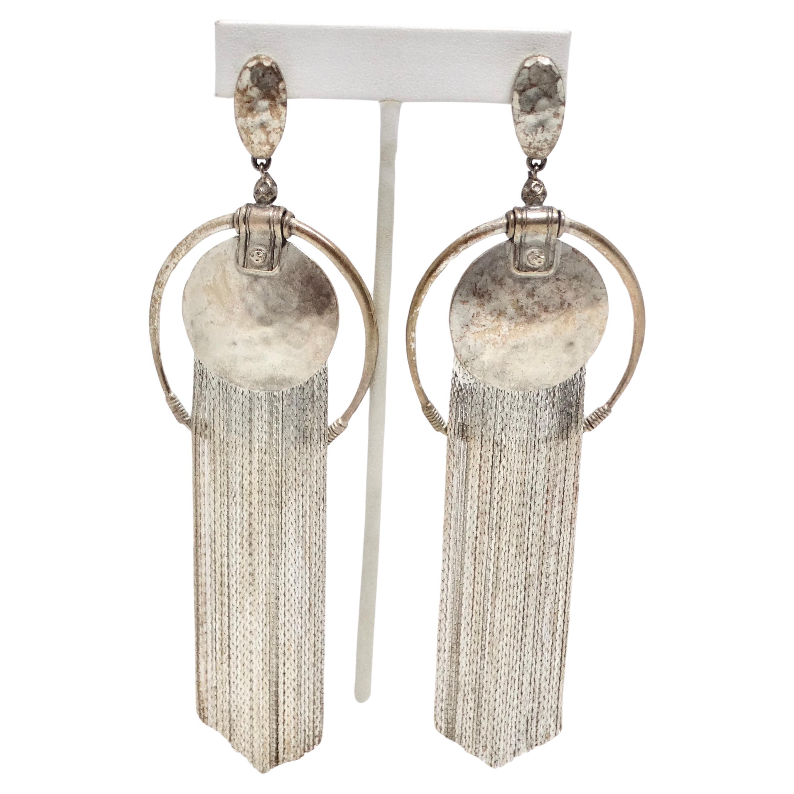 Get your hands on the Jean Paul Gaultier 1990s Silver Fringe Hoop Dangle Earrings, a stunning pair of statement earrings that reflect the artistry and iconic design of this renowned fashion designer. These earrings are the work of Jean Paul