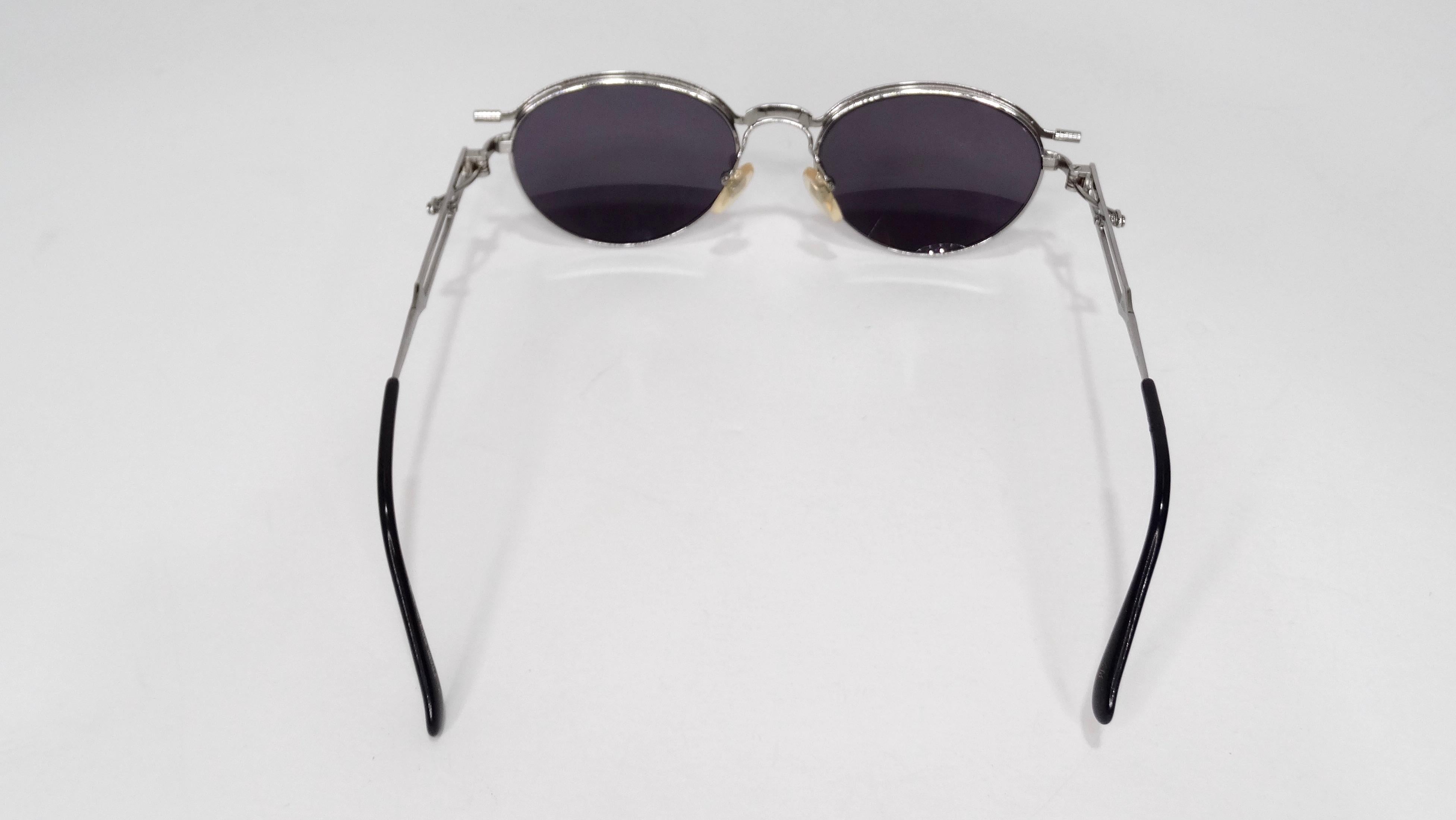 Elevate your look wit these amazing Jean Paul Gaultier sunglasses! Circa 1995, these sunglasses feature an industrial rounded frame with JPG embossed on the bridge and black lenses. A true outstanding designer piece, these sunglasses are perfect to
