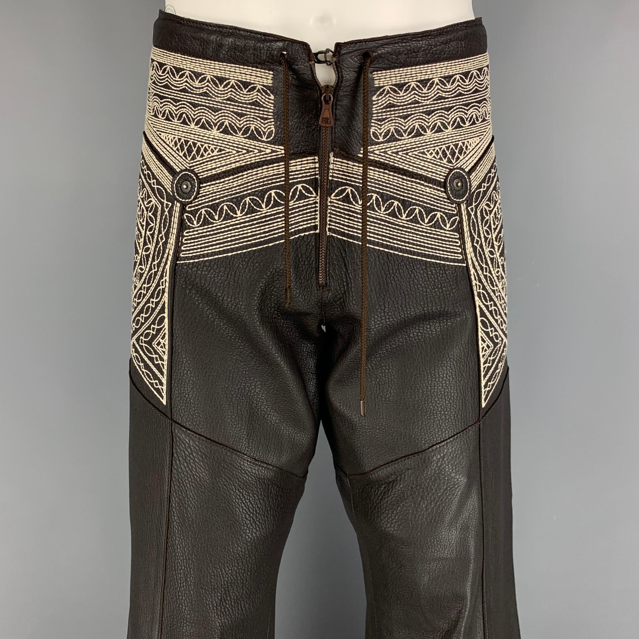 JEAN PAUL GAULTIER pants comes in a brown sheep leather featuring a relaxed fit, white embroidered details, back studded 'Gaultier' design, drawstring, zip fly, and a hook & loop closure. 

Very Good Pre-Owned Condition.
Marked: I 50 / E 50 / GB 40