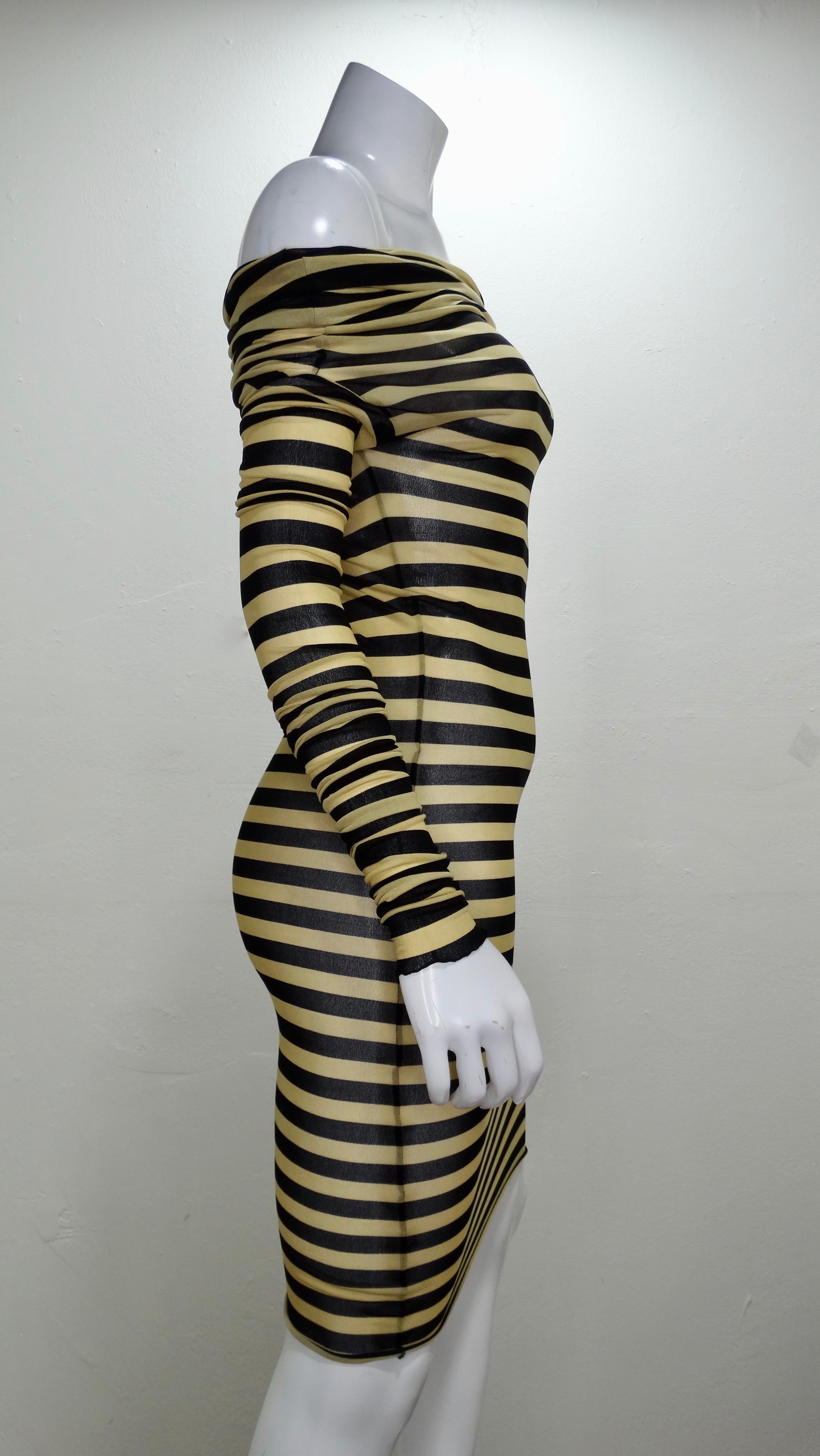 Rock an edgy look with this Jean Paul Gaultier dress! Circa 2003, this mesh dress features black and nude stripes with exaggerated long sleeves and a cowl neck. Figure hugging and extremely flattering, wear slightly off the shoulder with your