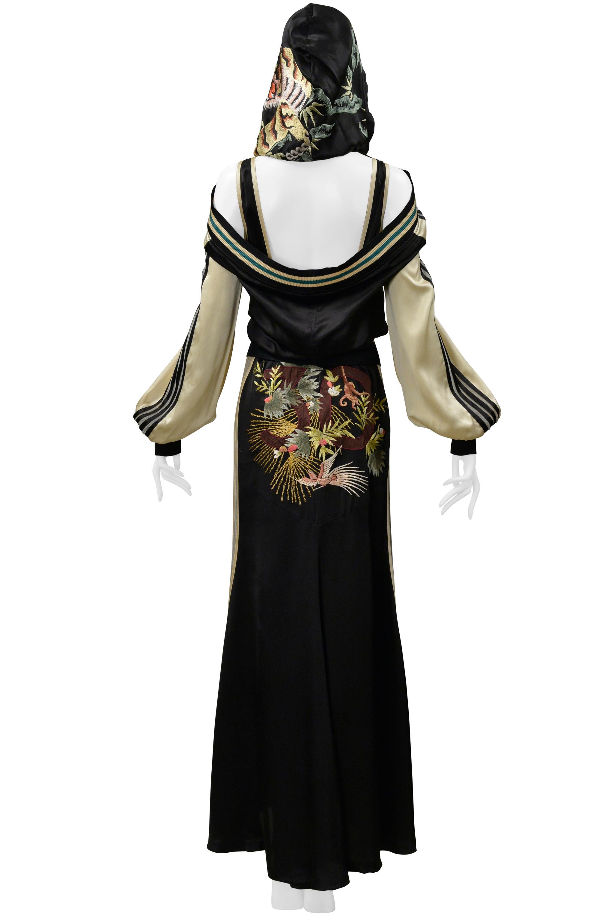 

Resurrection Vintage is excited to offer a vintage Jean Paul Gaultier black and cream satin ensemble with mesh stripes from 2007 30th anniversary collection. The ensemble includes a zip front jacket and long satin dress. The ensemble features
