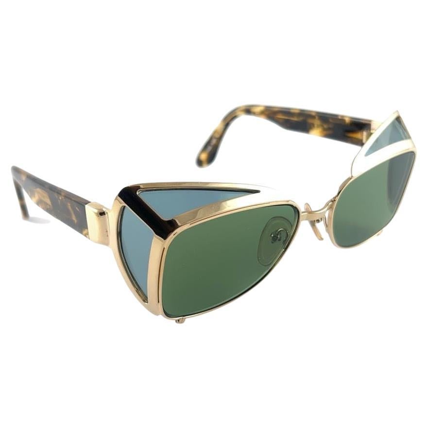 Collectors Item!!
Iconic Jean Paul Gaultier 56 8272 gold frame with tortoise temples. 
Dark green lenses that complete a ready to wear JPG look.
The very same model worn by Vanilla Ice in 1990's.
Amazing design with strong yet intricate