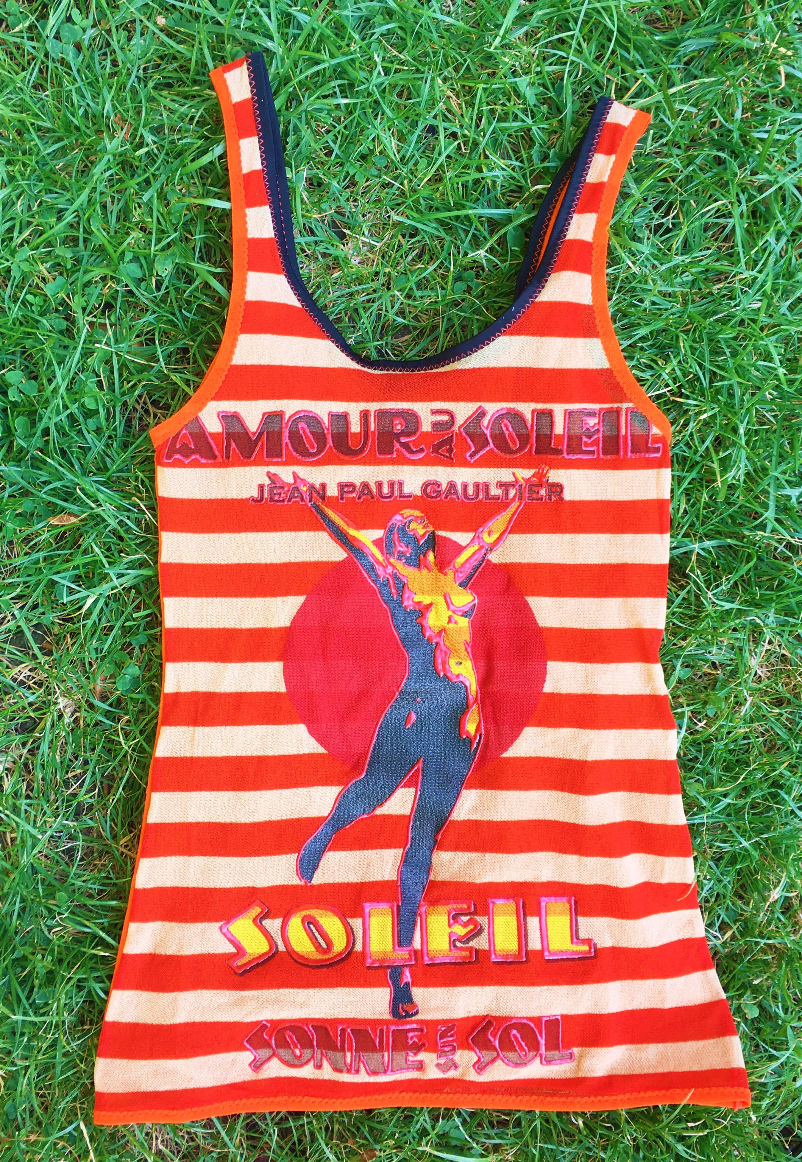 Amour au Soleil top by Jean Paul Gaultier!
Transparent :)

Text on the top: 
Jean Paul Gaultier
Amour au Soleil
Soleil 
Sonne Sun Sol

EXCELLENT condition!

SIZE
It fits from XS to medium.
Marked size: XS. Stretchy fabric!

Measurements unstretched