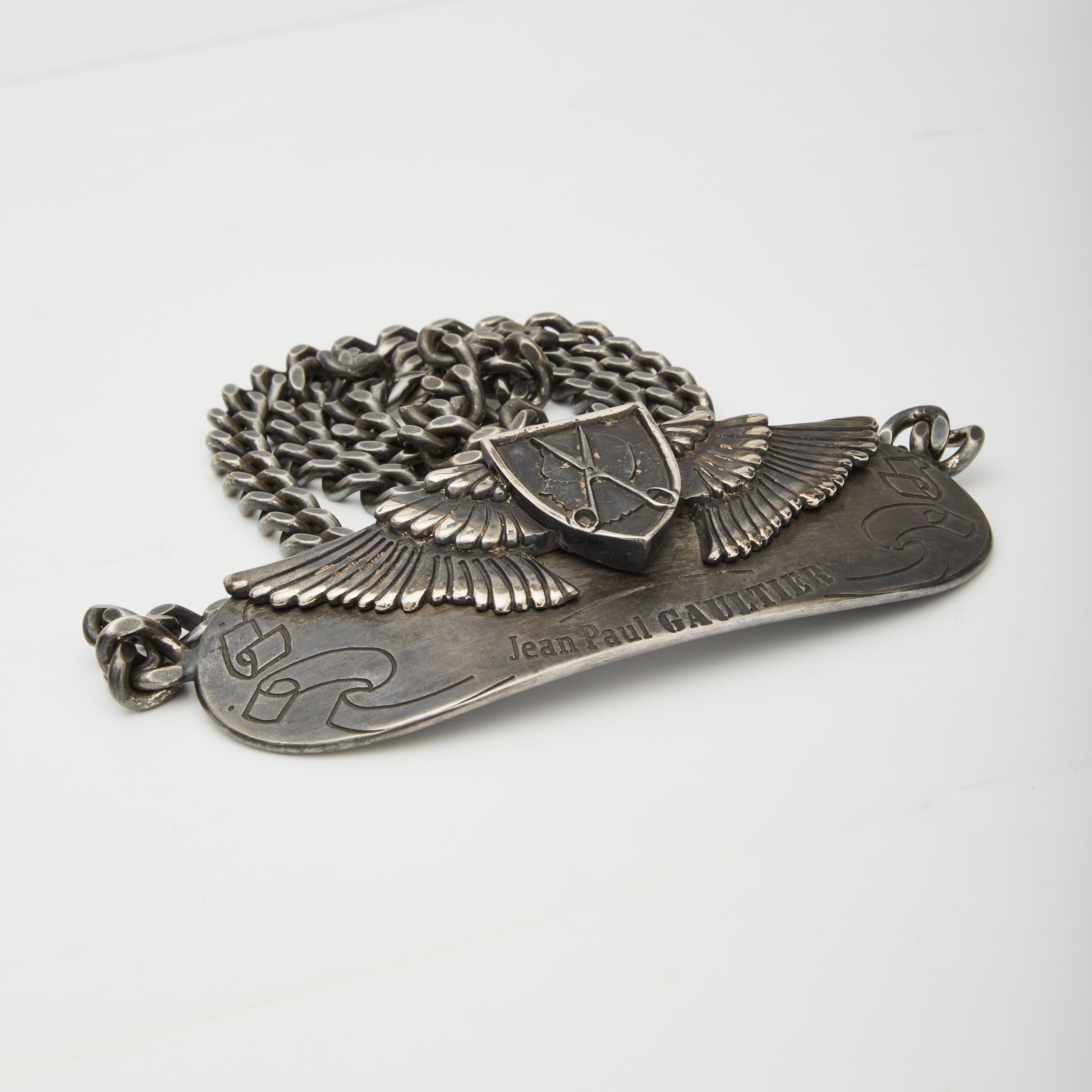 This belt by Jean Paul Gaultier features an antiqued silver tone color, a curb chain, a 3-D “buckle