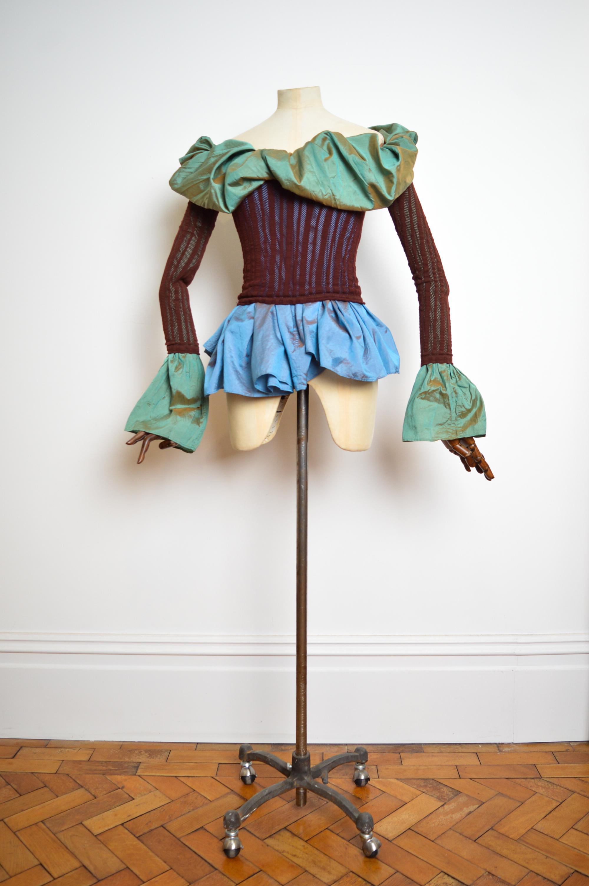 Superb, early 1990's 'Jean Paul Gaultier' avant-guard structured blouse in a maroon mesh with yards upon yards of sky blue & sea green teal irridescent taffeta. 

The real beauty of the garment is the super stretchy mesh fit that allows the wearer