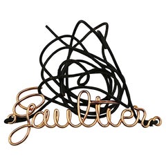 JEAN PAUL GAULTIER (zugeschrieben) Kupferfarbener dünner Gürtel mit geschwungenem Logo