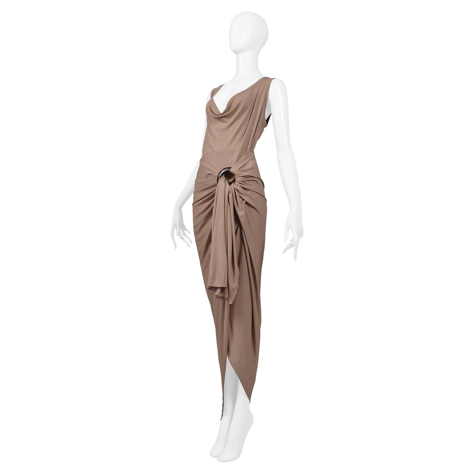 Resurrection Vintage is excited to offer a vintage Jean Paul Gaultier draped skirt and top ensemble. The skirt features gathered fabric at right hip with an invisible zipper, a large dark brown wooden bangle wrapped up at right hip, and an