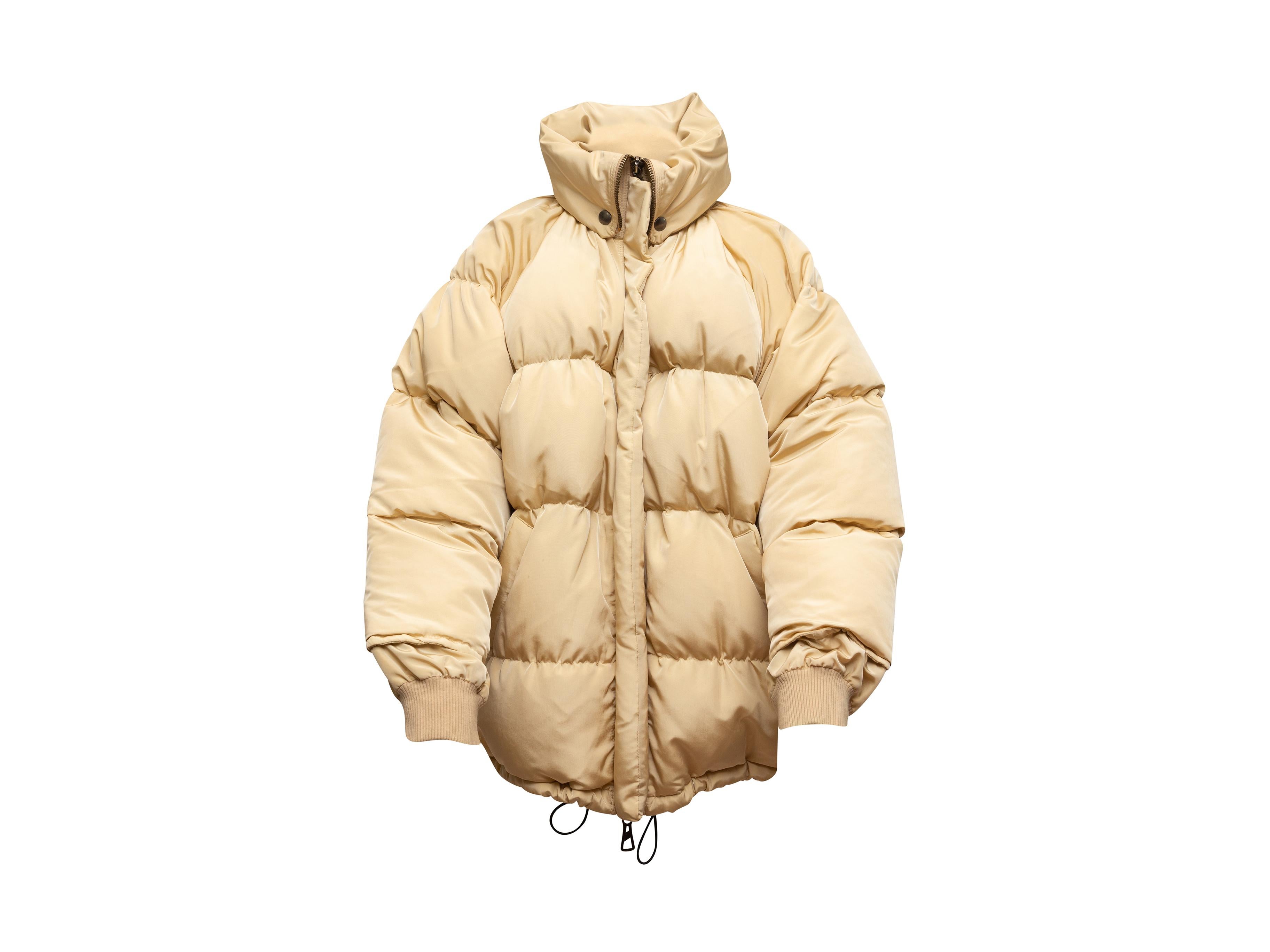 Product details: Vintage beige oversize puffer coat by Jean Paul Gaultier. Rib knit trim. Dual hip pockets. Zip closure at front. 47