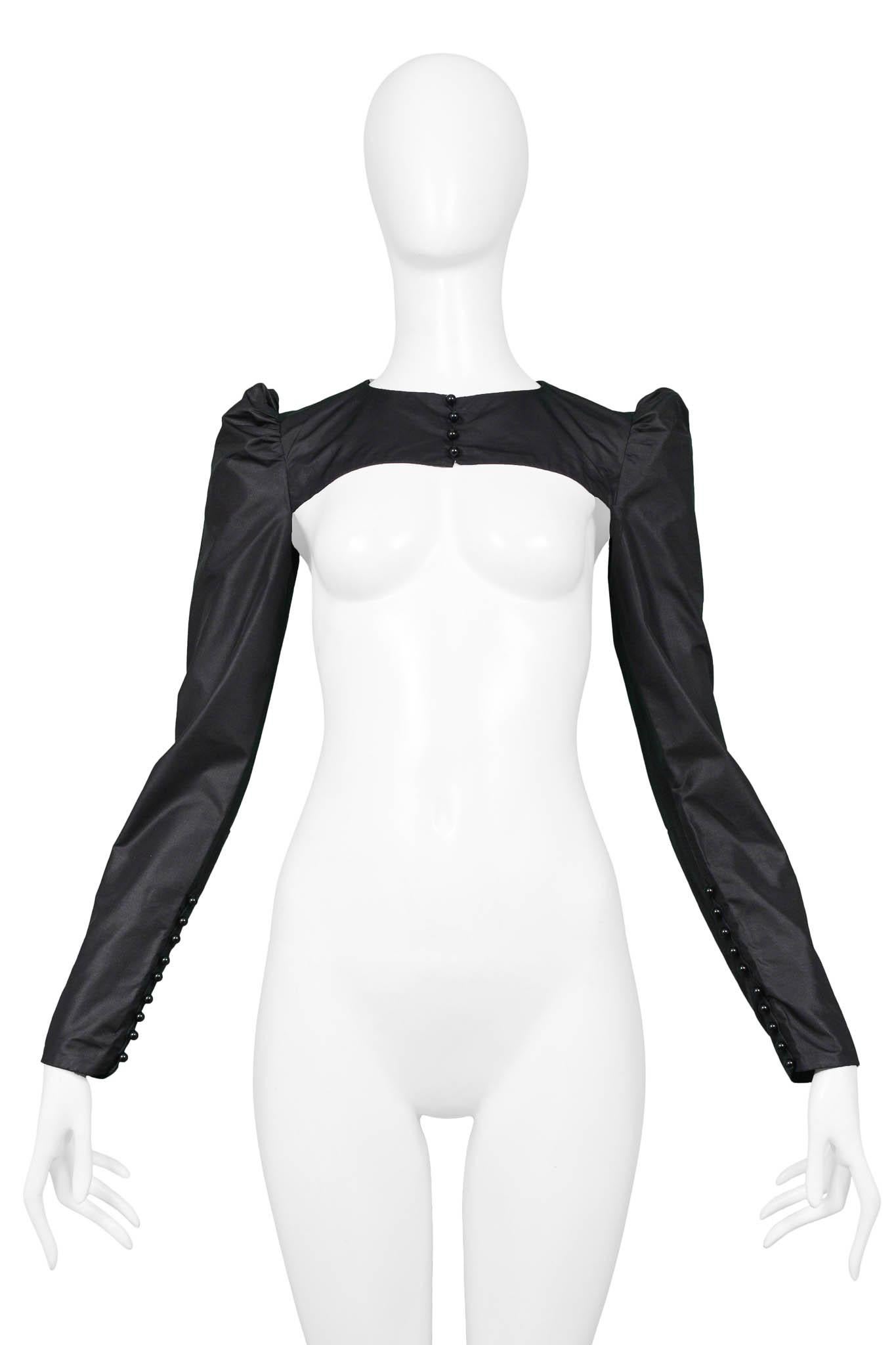 Resurrection Vintage is excited to offer a vintage Jean Paul Gaultier black cropped mini jacket featuring puff sleeves, front buttons, and back zipper.

Jean Paul Gaultier
Size: Small 
Silk, Polyester 
Excellent Vintage Condition
Authenticity