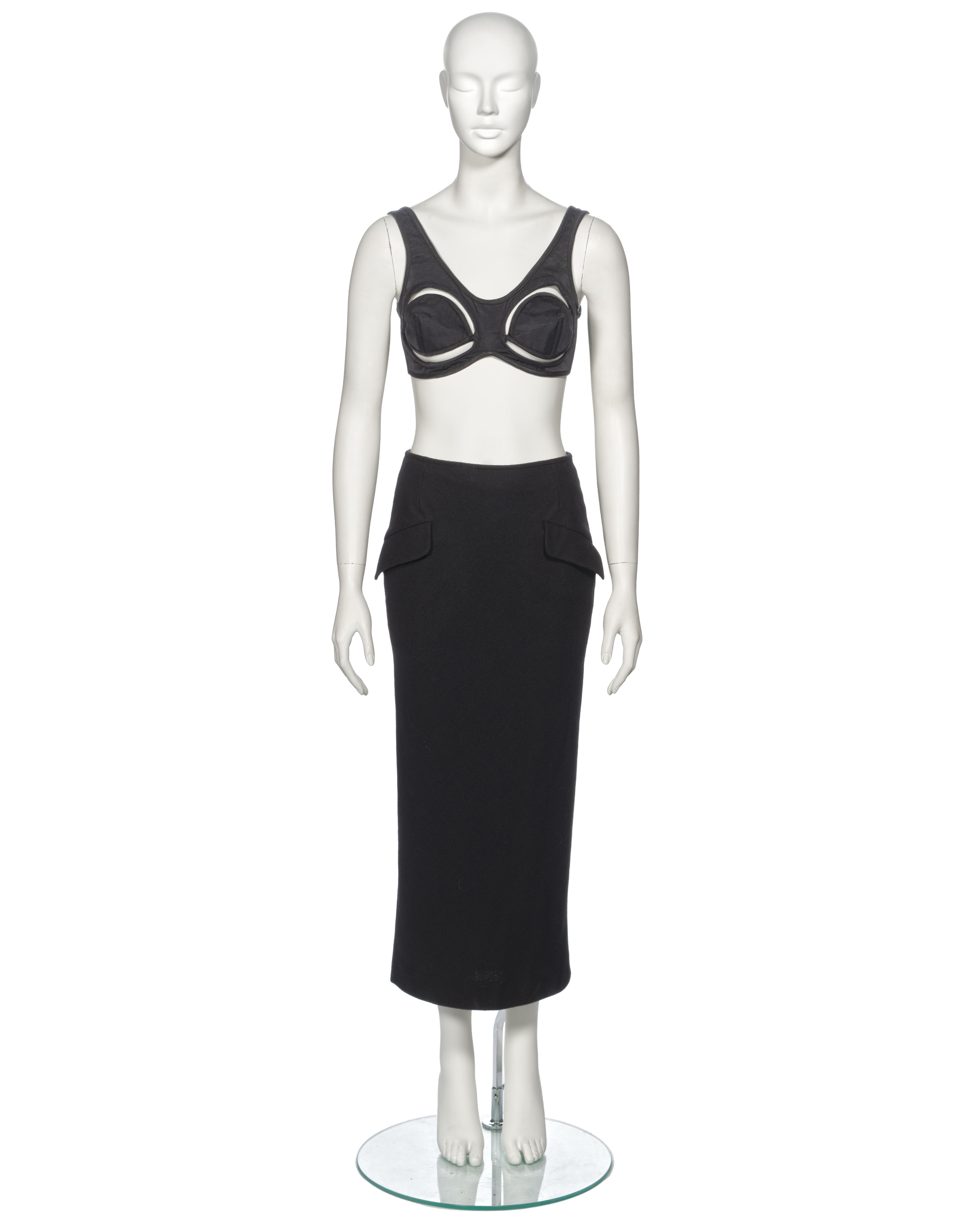 ▪ Archival Jean Paul Gaultier Evening Ensemble
▪ Spring-Summer 1993
▪ Sold by One of a Kind Archive
▪ Satin twill cone bra with cut outs and lace-up fastening 
▪ Wool crepe midi pencil skirt with two front flap pockets 
▪ Lined with turquoise satin