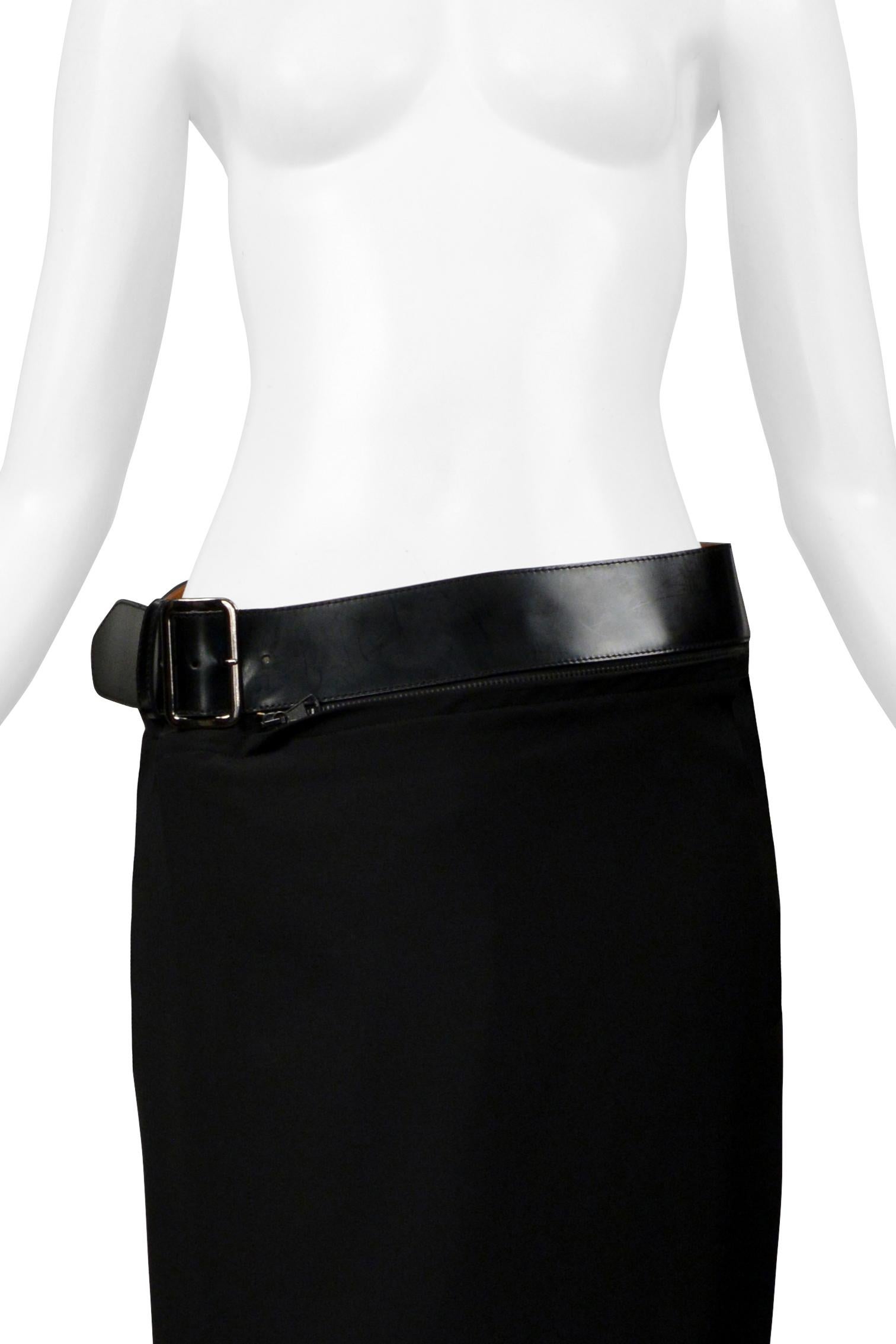 Resurrection Vintage is excited to offer a vintage Jean Paul Gaultier black gabardine straight skirt featuring a black hard leather belt with a wrap-around zipper, flat front, belt loop at the center back and ankle length.

* Jean Paul Gaultier
*