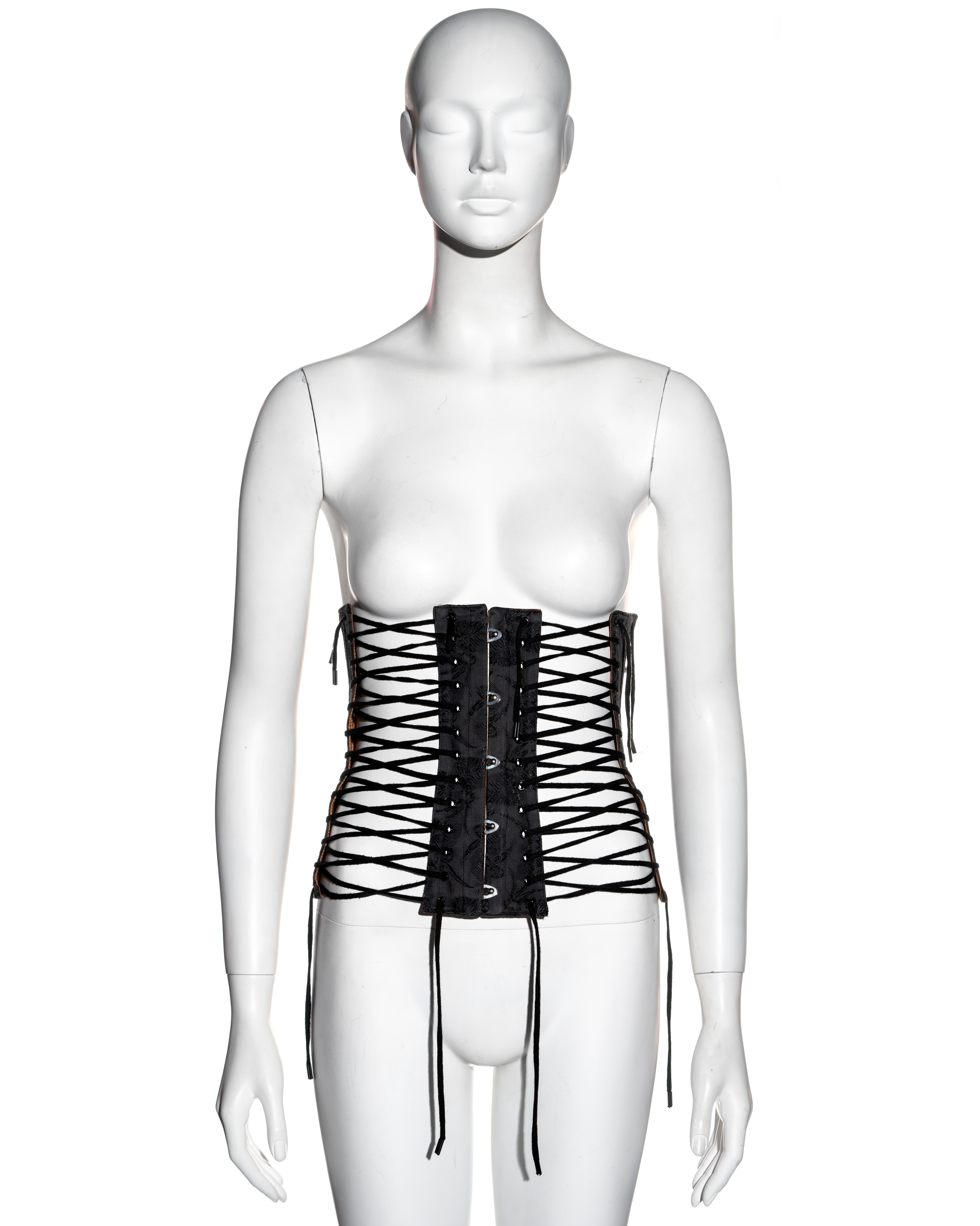 ▪ Jean Paul Gaultier black jacquard cotton corset 
▪ 56% Cotton, 44% Rayon 
▪ Tan leather backing 
▪ 4 lace up openings 
▪ Metal corset hook fasteners at centre front 
▪ IT 38 - FR 34 - UK 6 - US 4
▪ Spring-Summer 2004