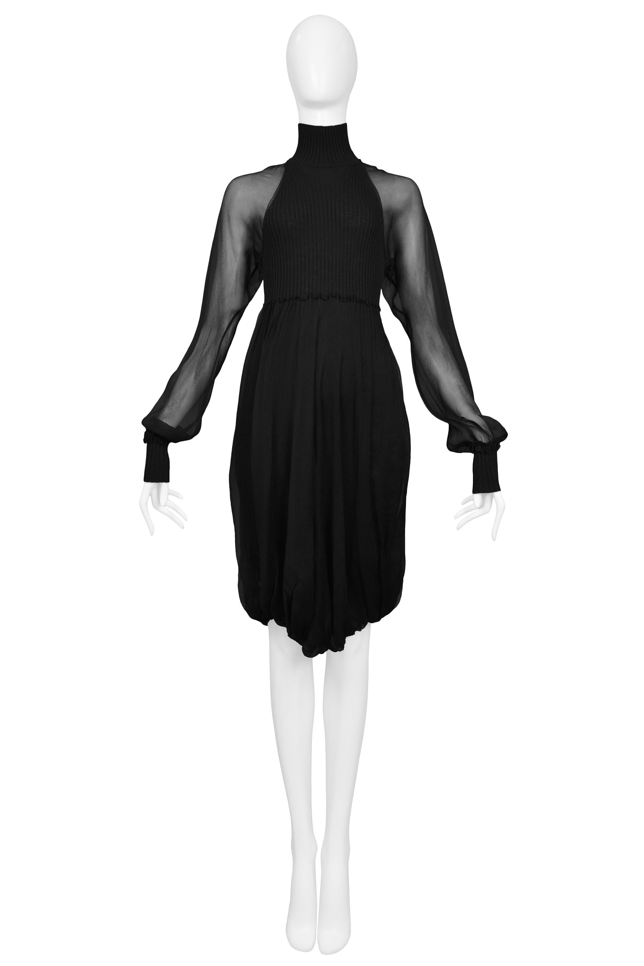Resurrection Vintage freut sich, ein schwarzes Jean Paul Gaultier Illusionskleid mit durchsichtigen Chiffon-Ärmeln, hohem Halsausschnitt, geripptem Mieder und Manschetten sowie drapiertem Rock anbieten zu können.

Jean Paul Gaultier
Größe: Klein
