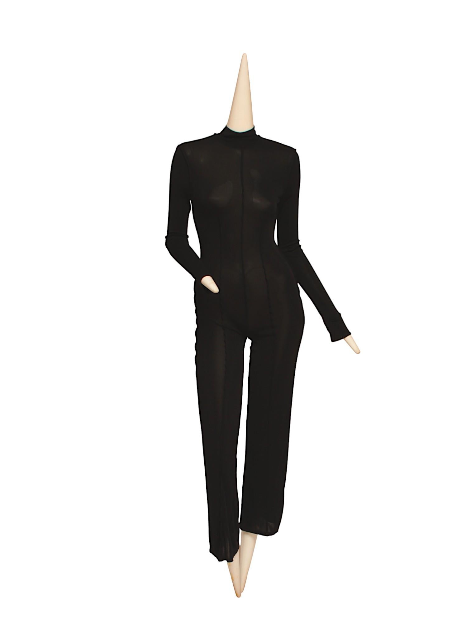 JEAN PAUL GAULTIER, tuta nera a maniche lunghe con cerniera posteriore e fondo svasato. Realizzato in materiale elastico artificiale. Chiusura con cerniera sul retro del collo.

