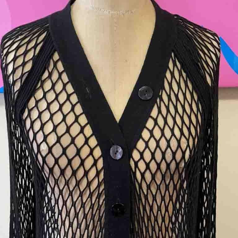 Edgy and cool are words usually associated with Gaultier. Since he no longer makes ready to wear, the pieces have become highly prized. This open weave cardigan has all the aspects you want with the brand! Pair with black leggings and boots for a