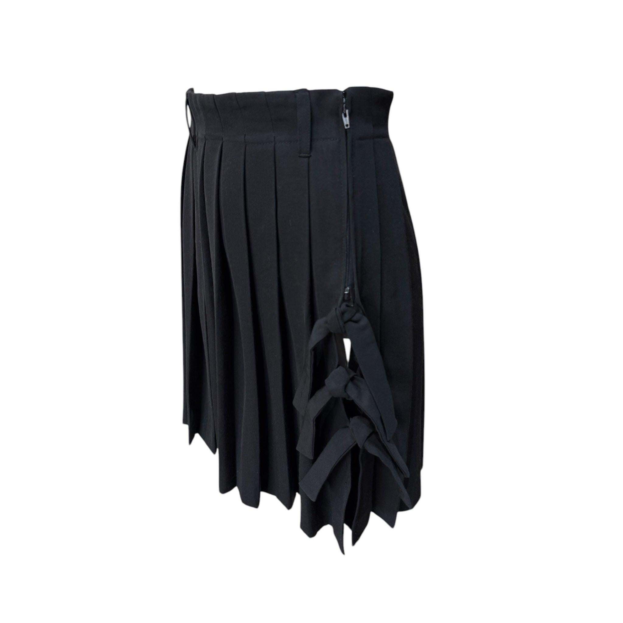 Jean Paul Gaultier FEMME label black tailored pleated mini skirt. Medium weight twill. Zipper closure with tie ribbon detailing below the zipper to expose the leg. Cheeky! In great condition. 

Additional information:
Dimensions: Labeled a size 40,