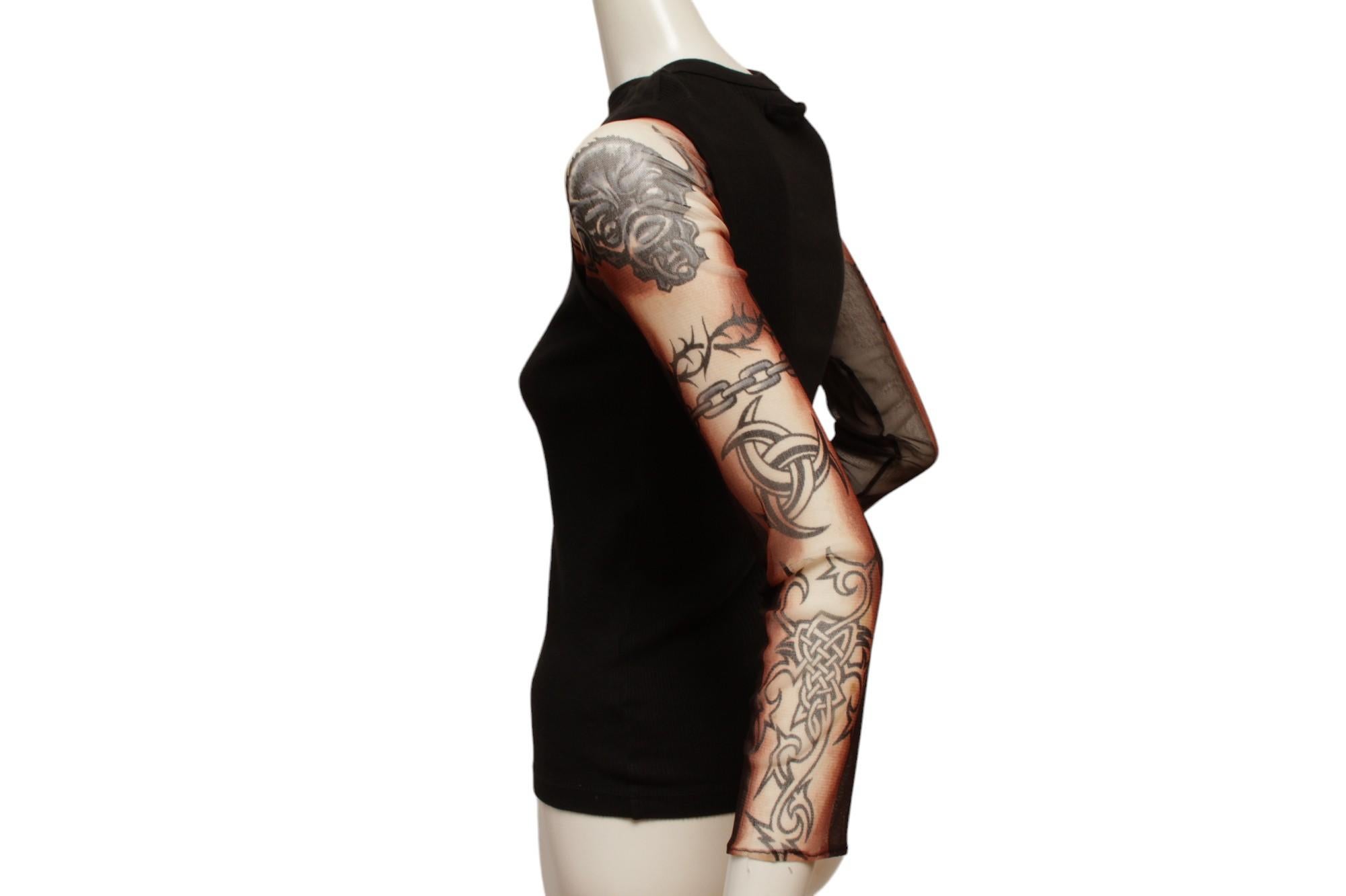 Jean Paul Gaultier Maille Black Rib Knit Tank with Mesh Tattoo Design Sleeve.

Made in Italy

Size Large Measurements: Shoulder 11.5