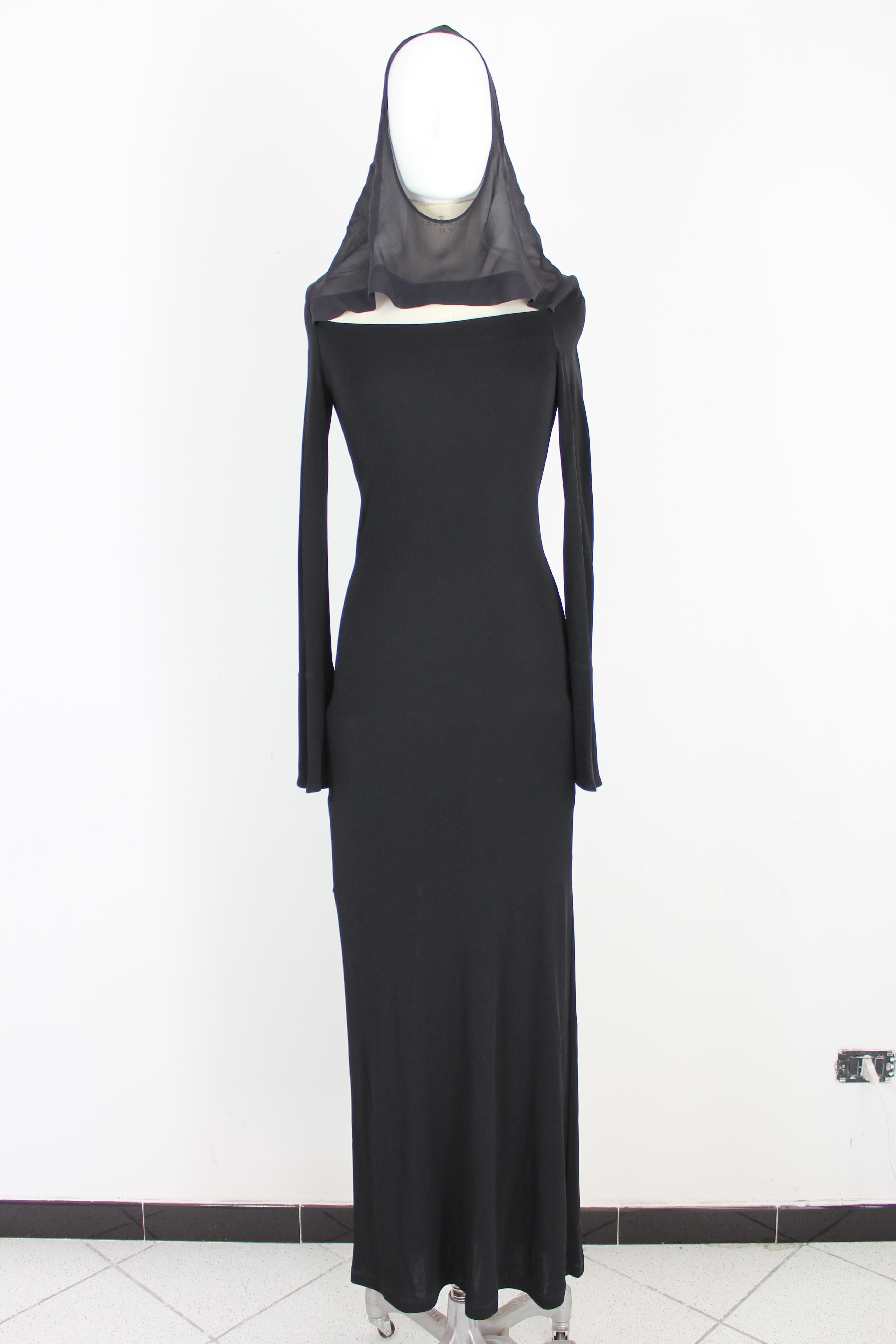 2000s Jean Paul Gaultier women's dress. Long evening dress 100% silk, bodycon model, black color, light hood that can turn into a soft collar. Long sleeve flared at the end. Made in Italy. Excellent vintage condition.

Size: 42 It 8 Us 10