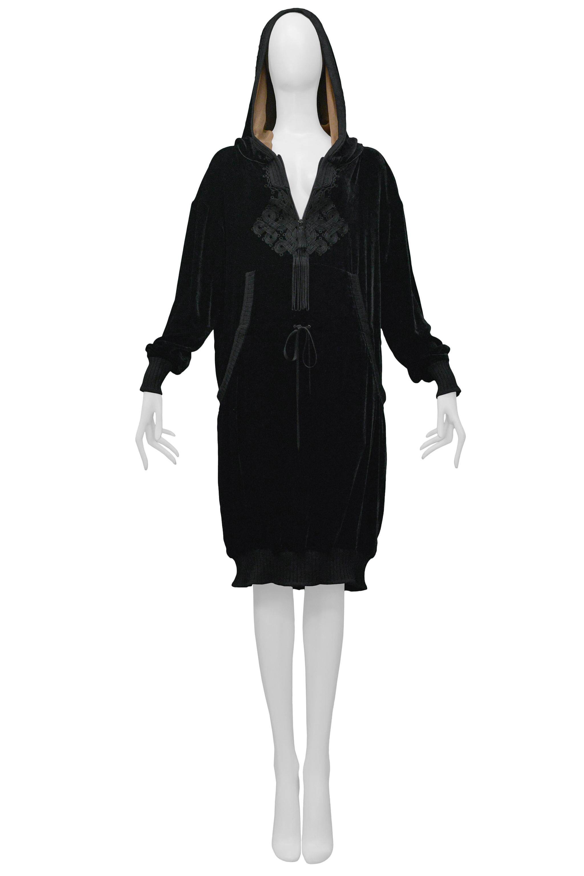 Resurrection Vintage is excited to offer a vintage Jean Paul Gaultier black velvet tunic dress featuring an embroidered pattern at the front, kangaroo pockets, a large tassel, and a hood lined with beige chiffon.

Jean Paul Gaultier
Size: 42
80%
