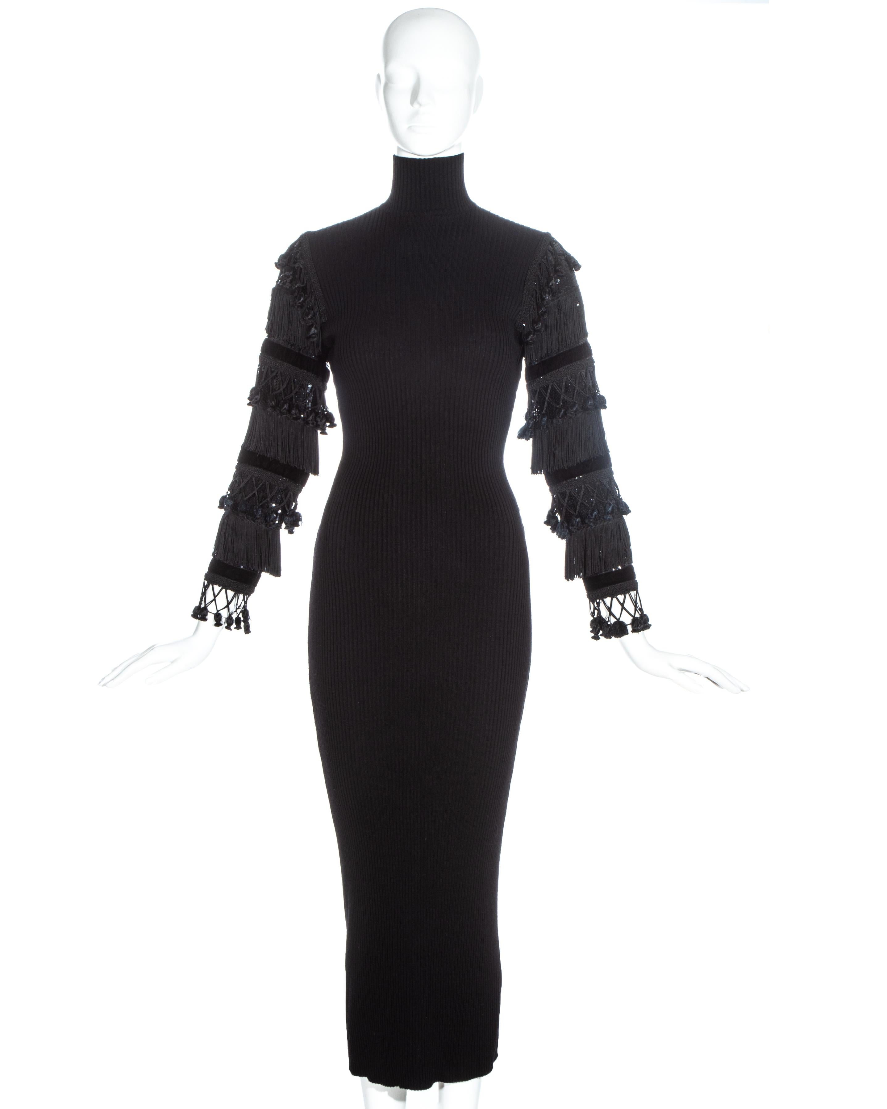 Jean Paul Gaultier black ribbed wool turtle neck maxi dress with velvet, sequin and tasseled sleeves.

Fall-Winter 1985