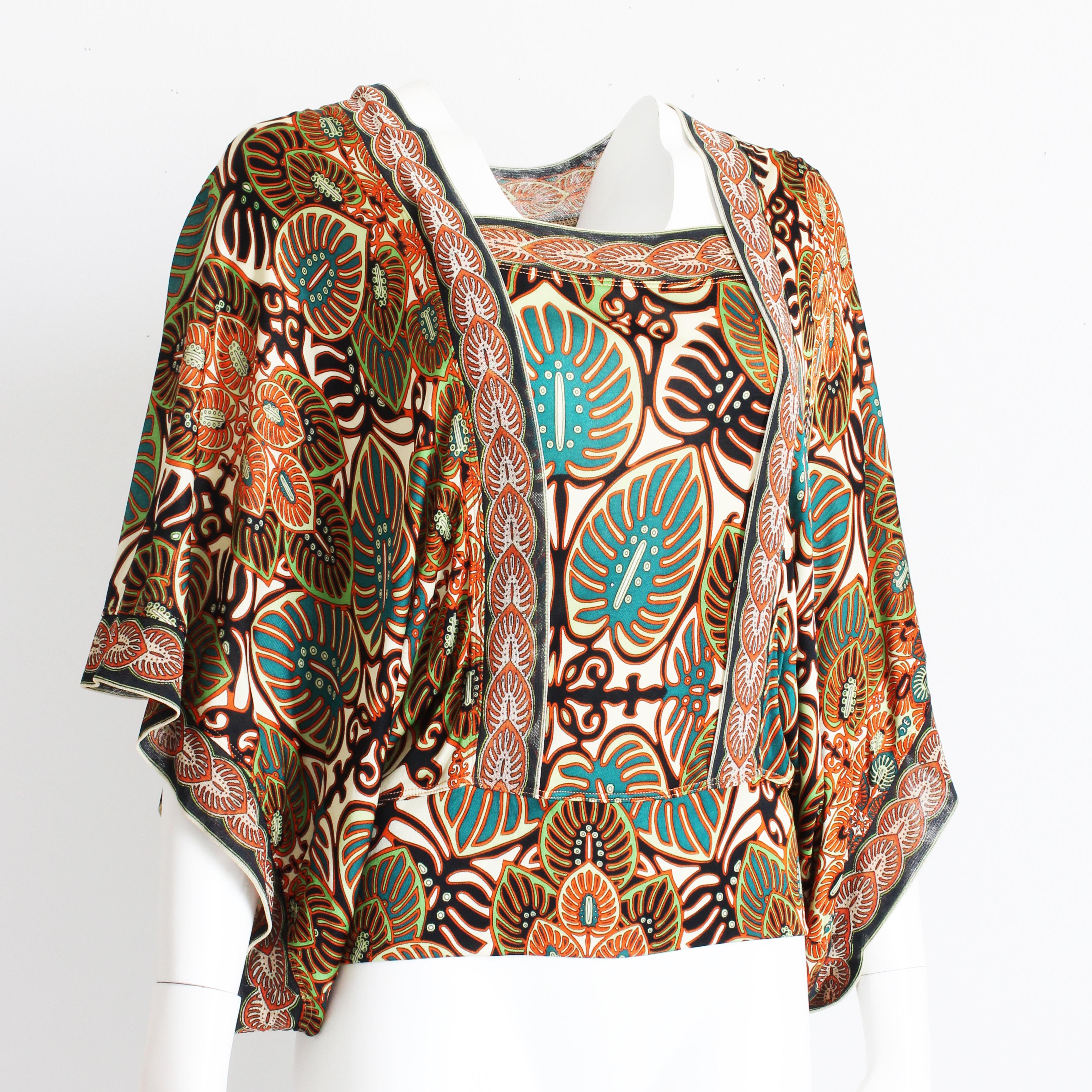 Authentique blouse à manches d'ange vintage Jean Paul Gaultier, d'occasion, probablement réalisée dans les années 90. Confectionnée dans une maille à imprimé abstrait fabuleusement vibrant dans des tons de rouge, d'orange, de sarcelle et de noir,