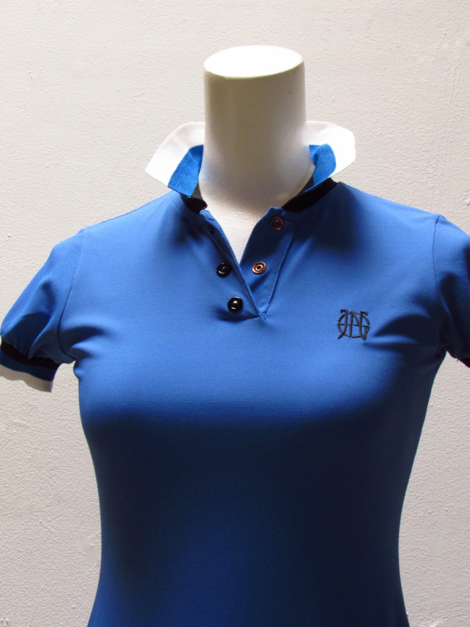 Classic polo-style dress comes from vintage Jean Paul Gaultier in a bright blue. The collar and cuffs feature contrasting bands of black, blue and white. The JPG logo appears on the left breast. 