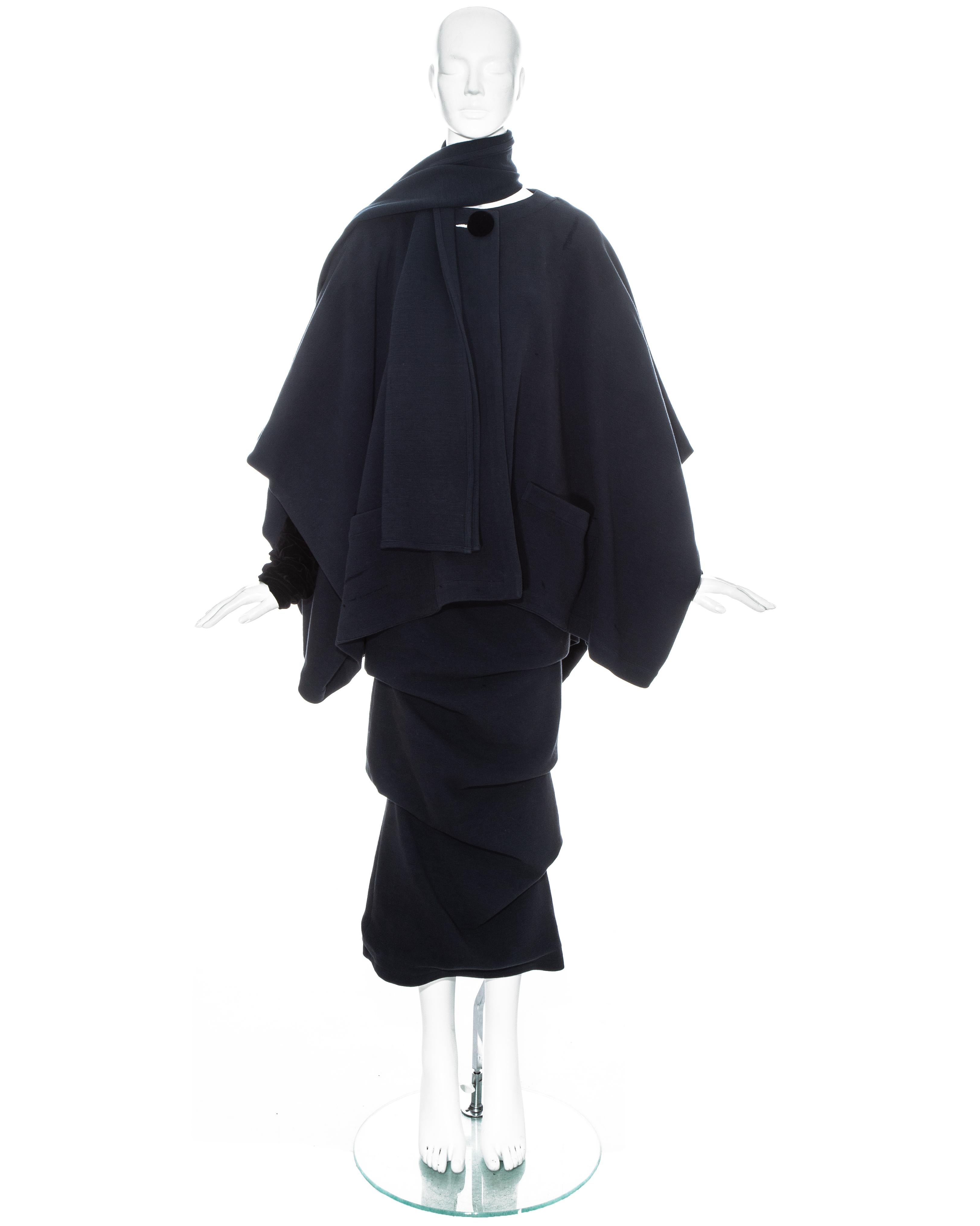 Jean Paul Gaultier blue wool ensemble comprising: cape jacket with black velvet sleeves and large button fastening, ruched ankle length skirt and matching scarf. 

Fall-Winter 1984