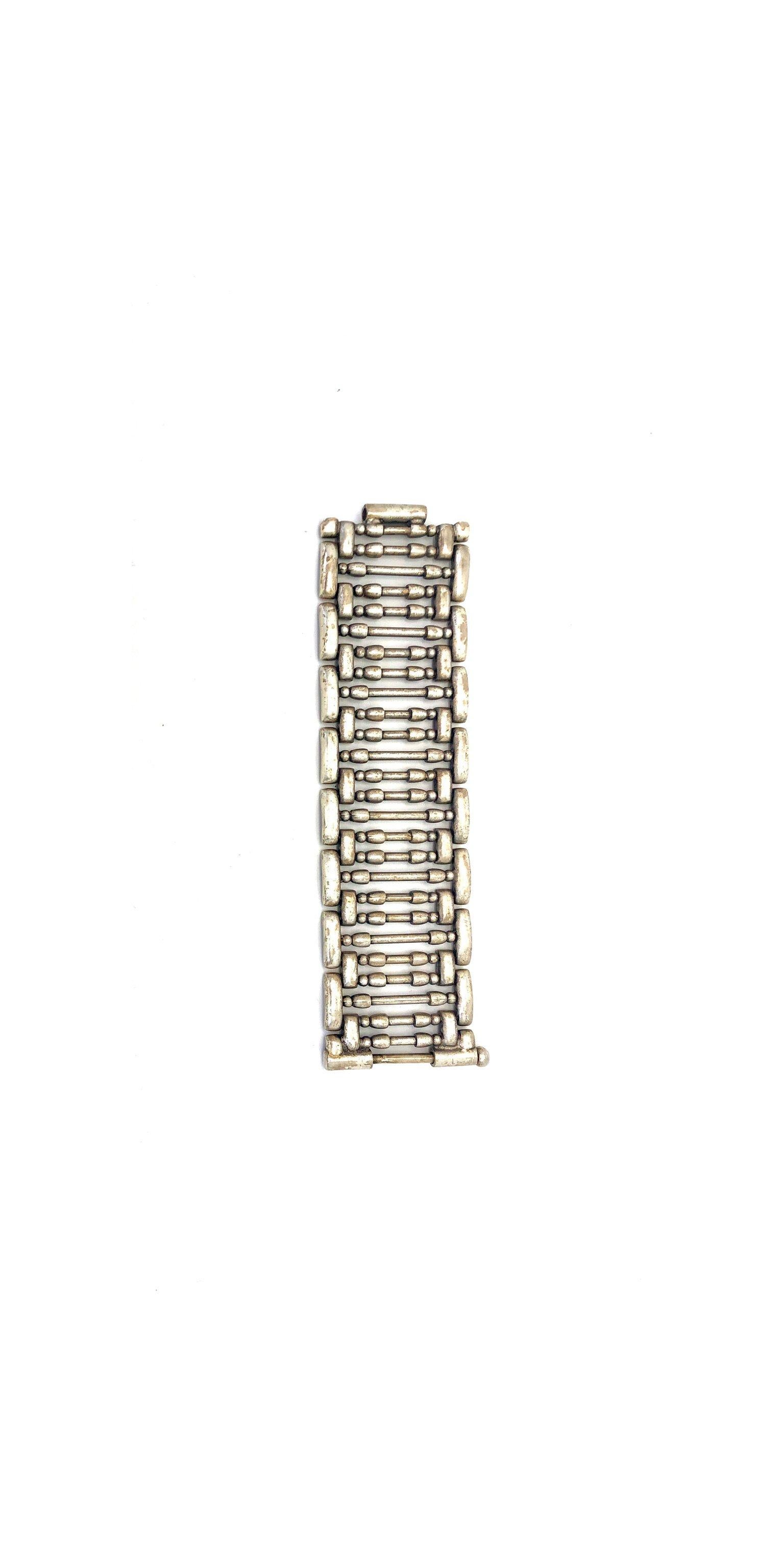 Jean Paul Gaultier Vintage Cuff Bracelet. 

This striking statement cuff is from the 90s Gaultier archive. Cast from heavyweight silver tone metal, it comprises of a multitude of metal bars framed with chunky links. It’s wide oversized silhouette