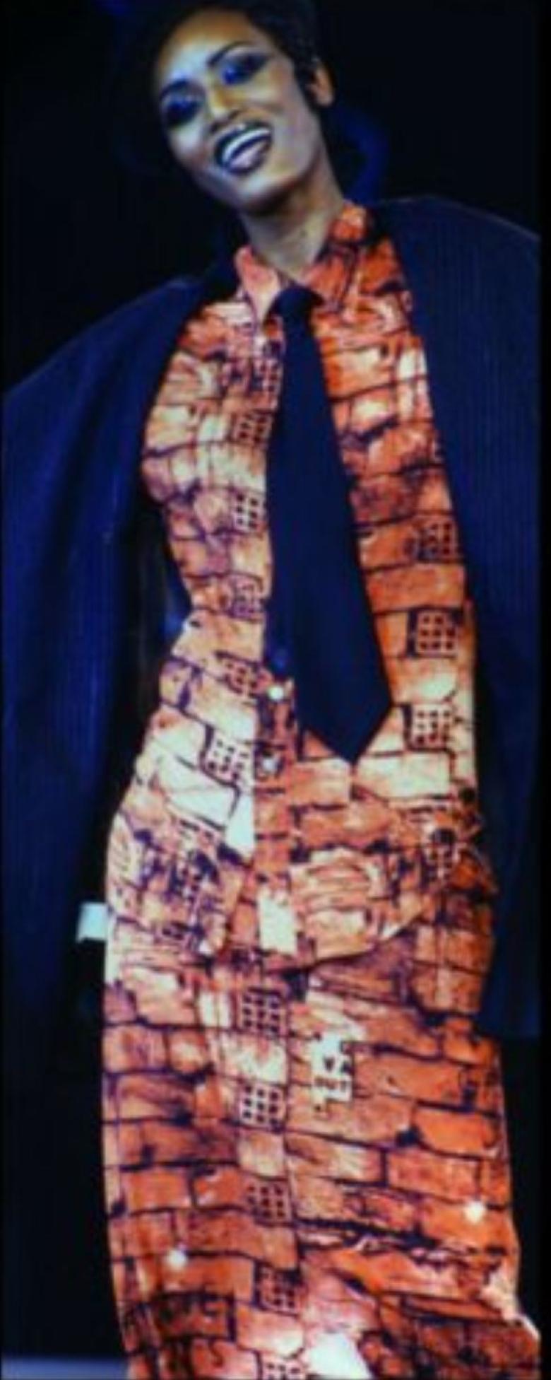 Stunning vintage Jean Paul Gaultier dress, documented and shown here on the Fall/Winter 1997 runway. This dress features an iconic and well-known graphic brick print that has graffiti like Gaultier Jeans throughout. Fight against racism