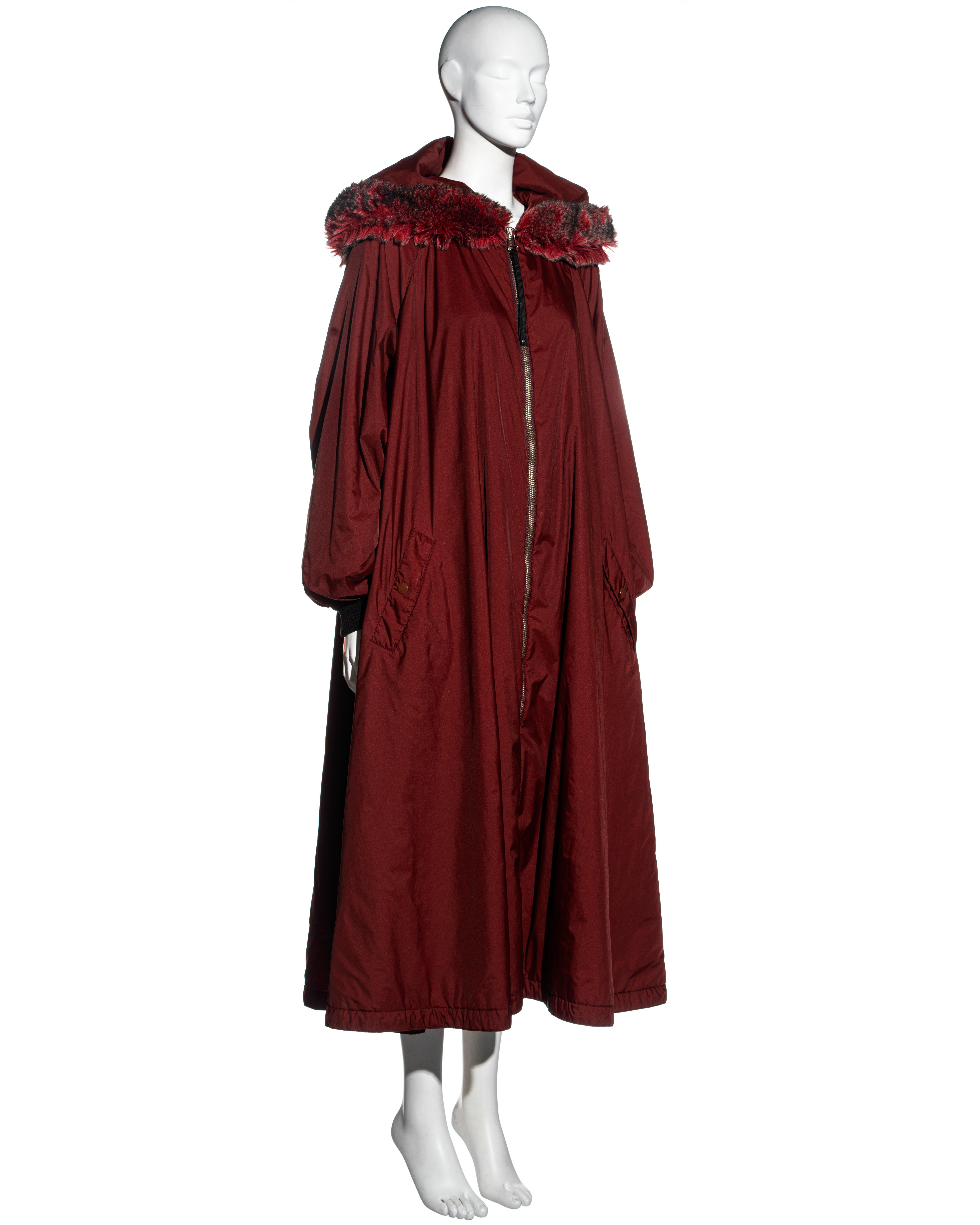 ▪ Jean Paul Gaultier burgundy nylon puffer coat dress
▪ Oversized pointed hood with faux fur trim
▪ Metal zipper at the center front opening 
▪ Two front pockets 
▪ Elasticated cuffs 
▪ IT 42 - FR 38 - UK 10
▪ Fall-Winter 1995