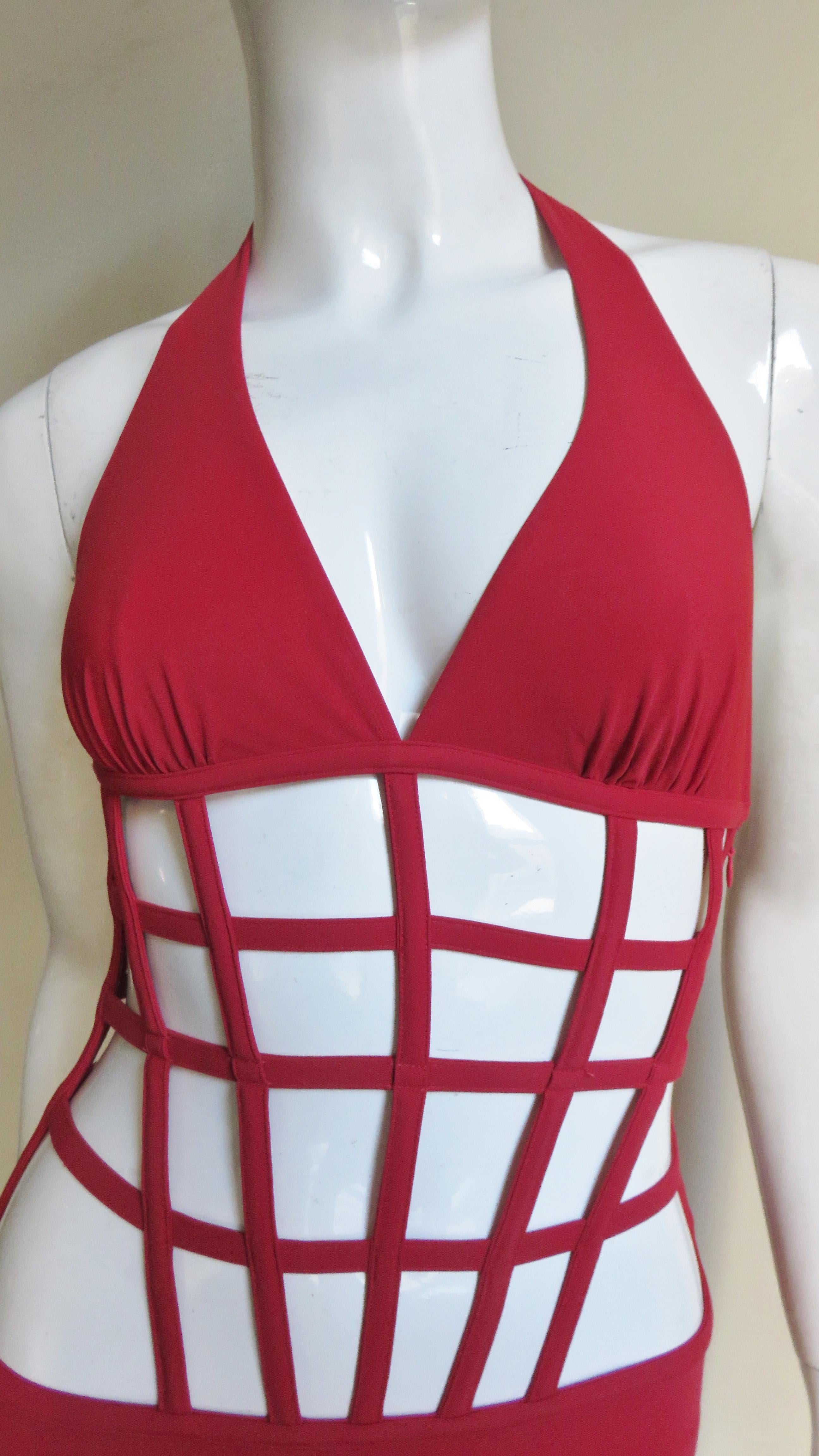 A fabulous red swimsuit from Jean Paul Gaultier for La Perla.  It has a halter style top and a bikini bottom joined with boned horizontal and vertical strips creating a geometric effect.  There is a side invisible zipper and ties at the back of the
