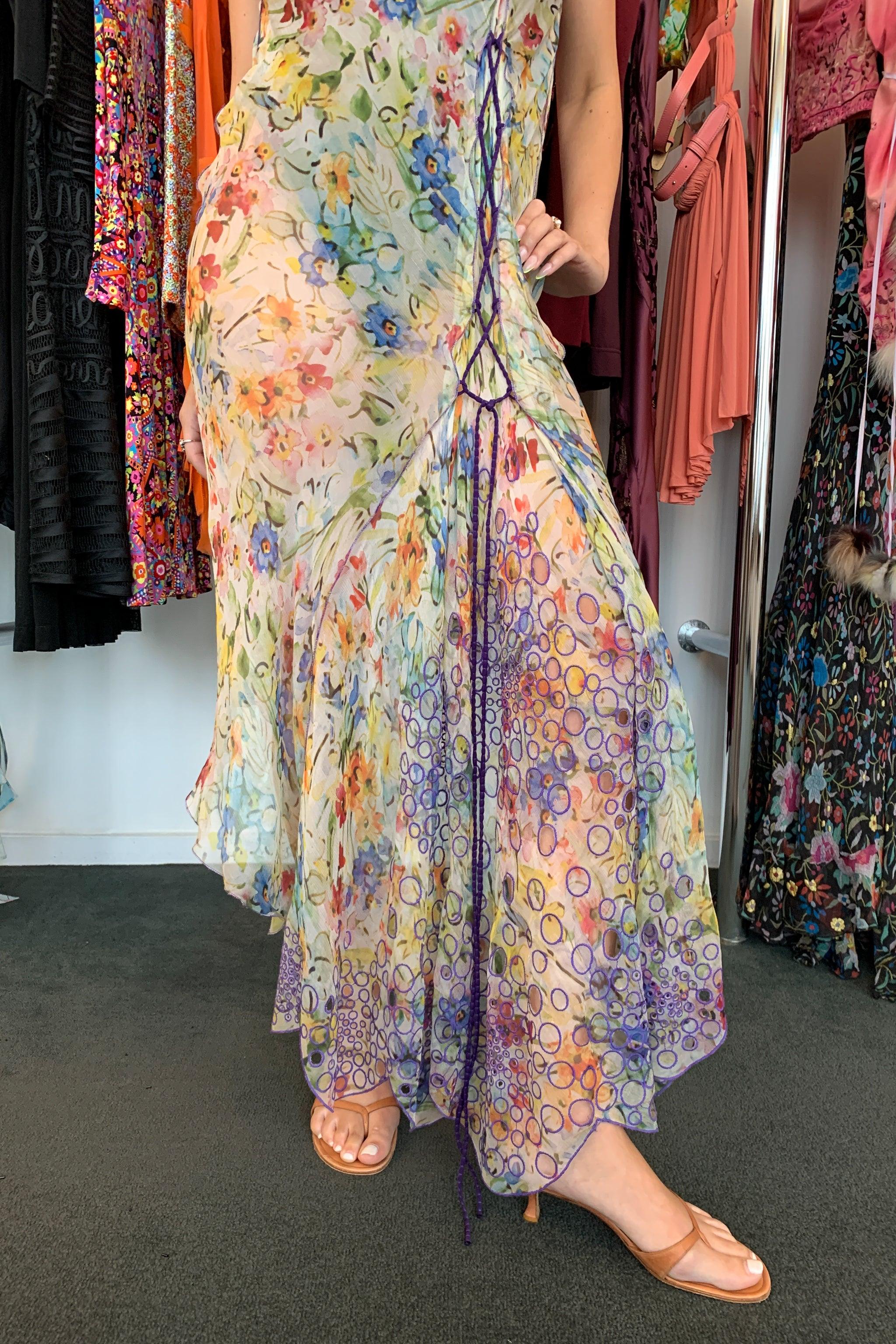 Resurrection Vintage is excited to offer a vintage Jean Paul Gaultier sheer chiffon slip dress featuring a delicate multicolor floral print, a panel of purple embroidered circles, asymmetrical corset side laces, purple cord straps, and an