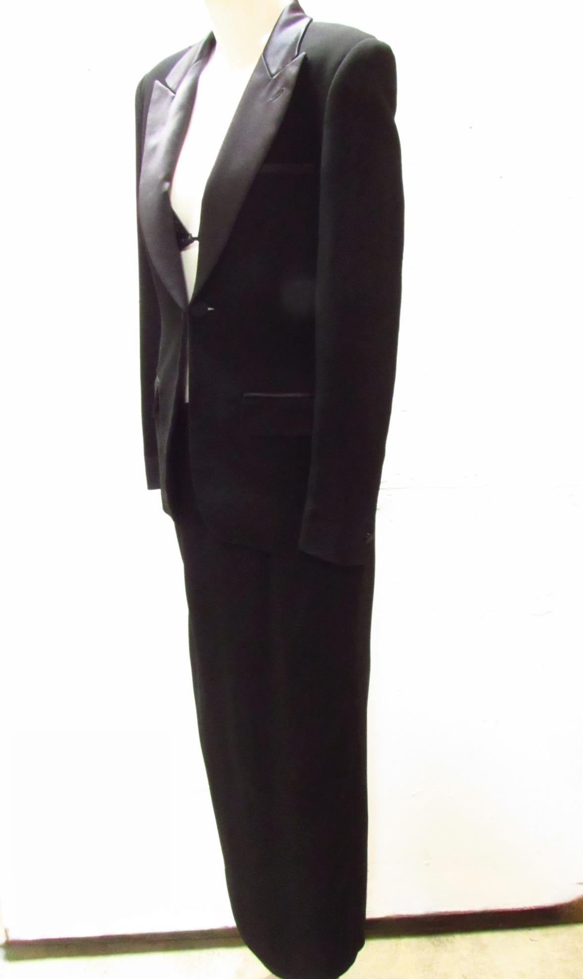 Vintage Jean Paul Gaultier black tuxedo-style dress. The skirt portion is secured with a zipper and hook & eye closure. The elegant jacket features satin cuffs and collar and two front buttons, while the back zips up to the collar's hook and eye