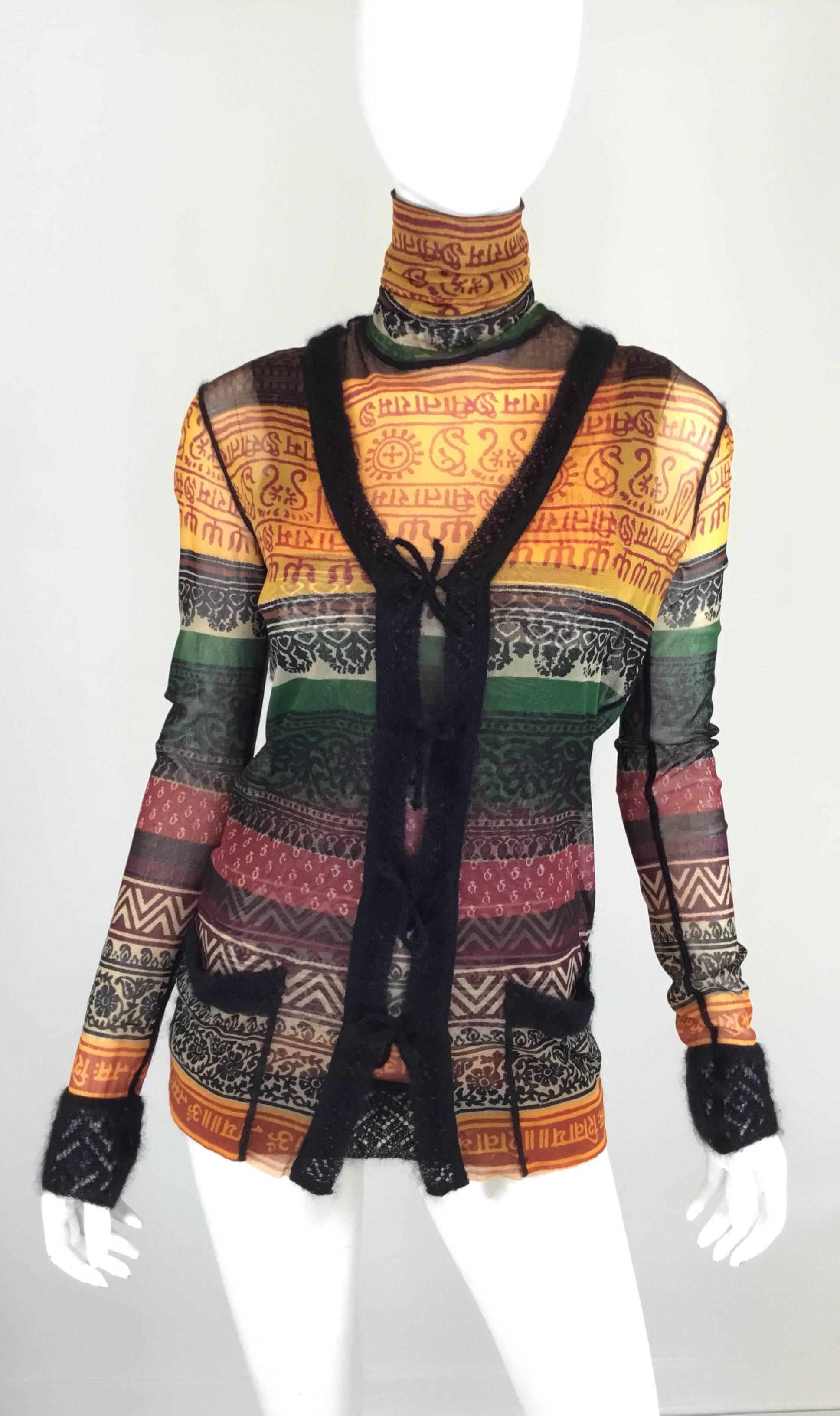 Jean Pail Gaultier top features a multicolored print throughout and knitted wool trimmings. Cardigan has knit wool string tie closures along the front and tank top has a turtleneck style with knitted trimmings along the hem. Cardigan is labeled a