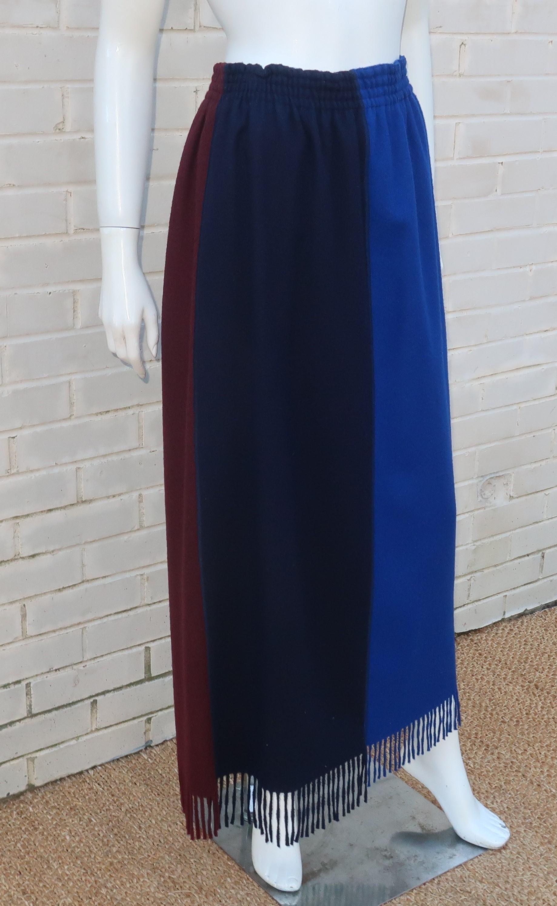 Jean Paul Gaultier pull on wool skirt with a four panel color block design including shades of bright blue, midnight blue (almost black), brown and teal.  The maxi length and fringe hemline provide both a stylish and cozy look especially when paired