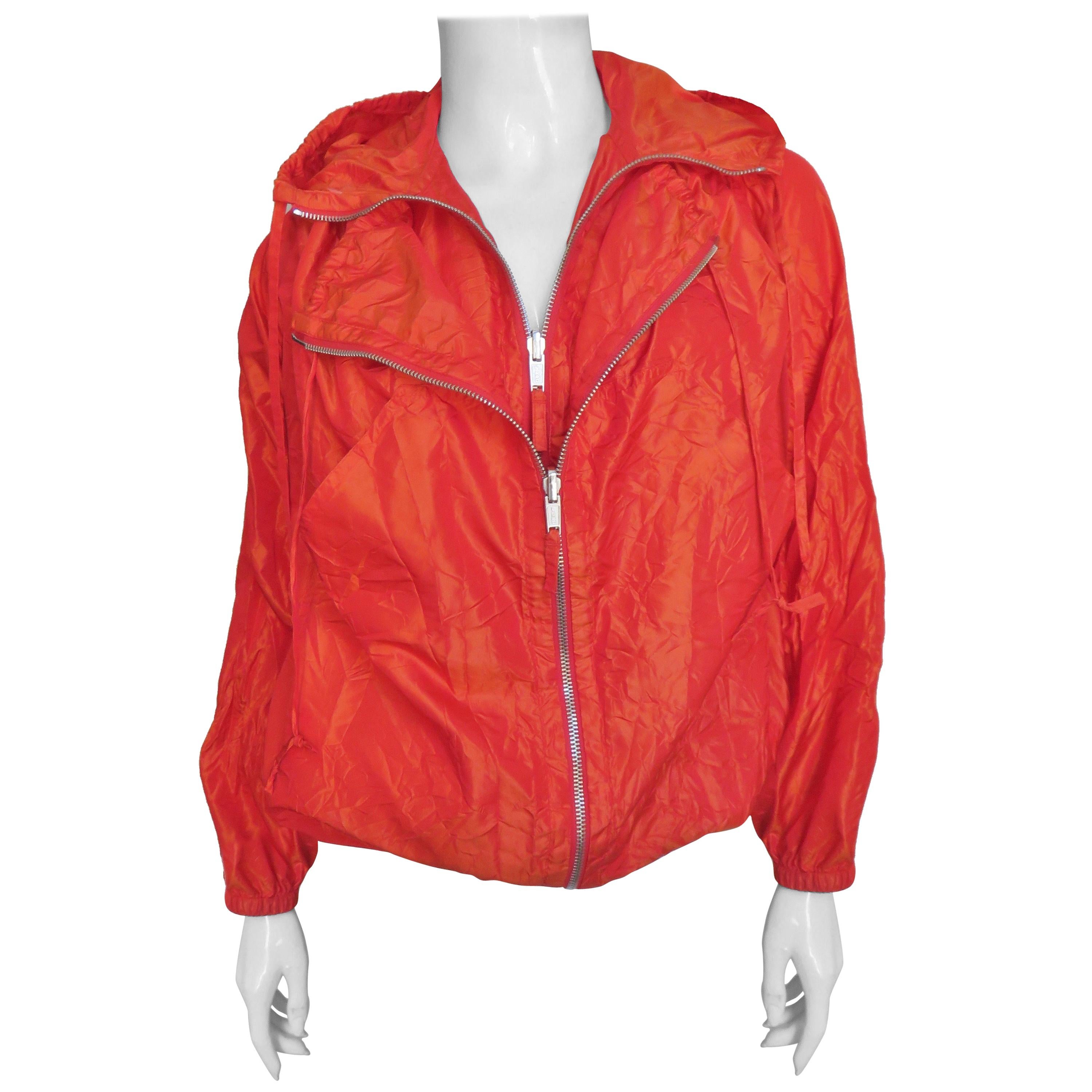A fabulous orange sleeveless long vest/dress that folds up and becomes a long sleeve bomber jacket. There is a drawstring at the hem and hood and gathers at the waist which has stretch. When worn full length the sleeves tie at the back hem.  When