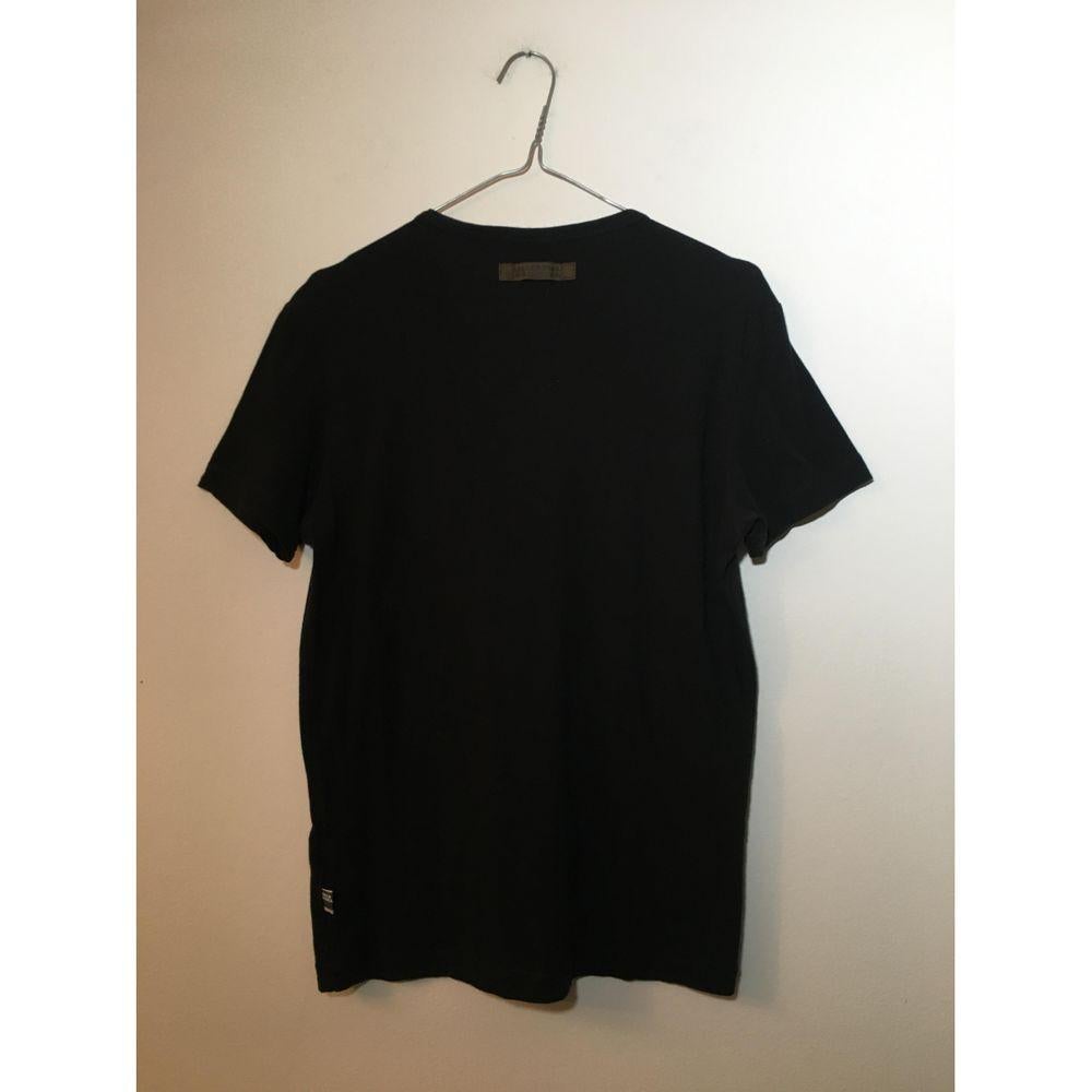 Jean Paul Gaultier Cotton T-Shirt in Black

Jean Paul Gaultier t shirt. 
In cotton and elastane. Size M. Measures 42cm in shoulders, 46cm in bust, 66cm in length. In good general condition, it has a white halo near the print.

General