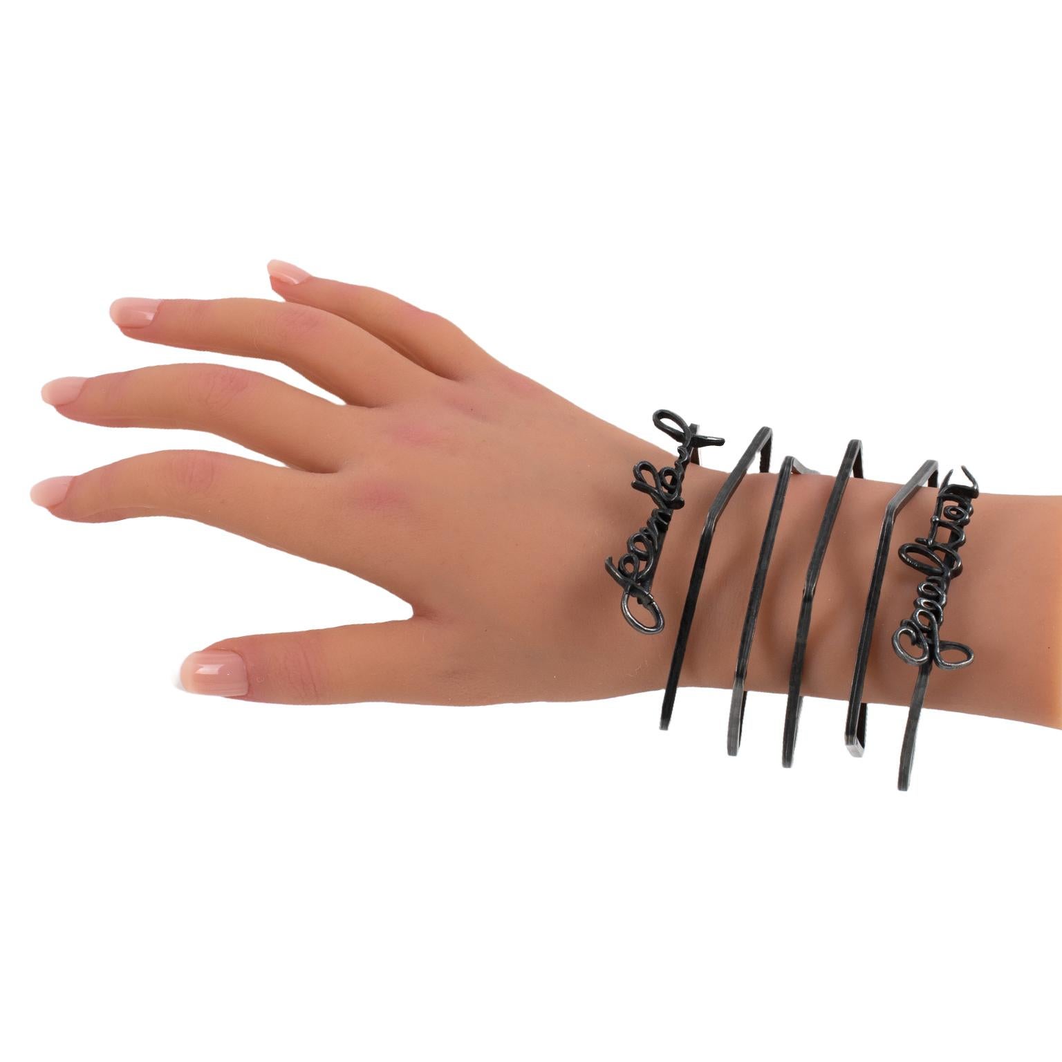 This impressive Jean Paul Gaultier Paris oversized metal cuff bracelet is from the Spring 2013 ready-to-wear runway collection. This bangle is documented. Check the last picture for reference. The piece features a blackened metal square coiled wide