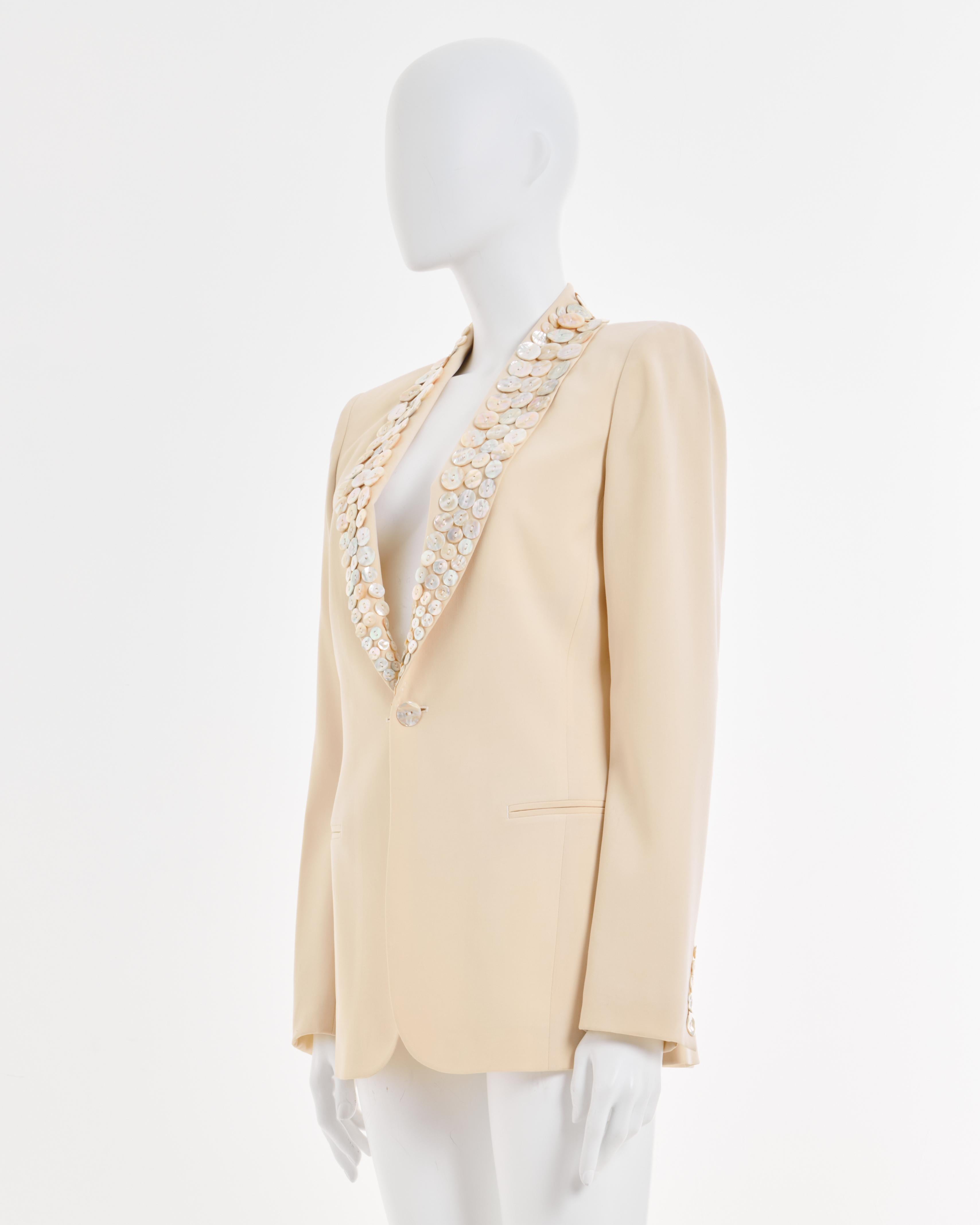 - Jean Paul Gaultier Wool Cream embellished button blazer-
- Sold by Skof.Archive 
- Spring-Summer Couture 2003
- Large iridescent mother of pearl buttons attached along lapels 
- Shawl collar with single button closure 
- Lightweight wool suiting