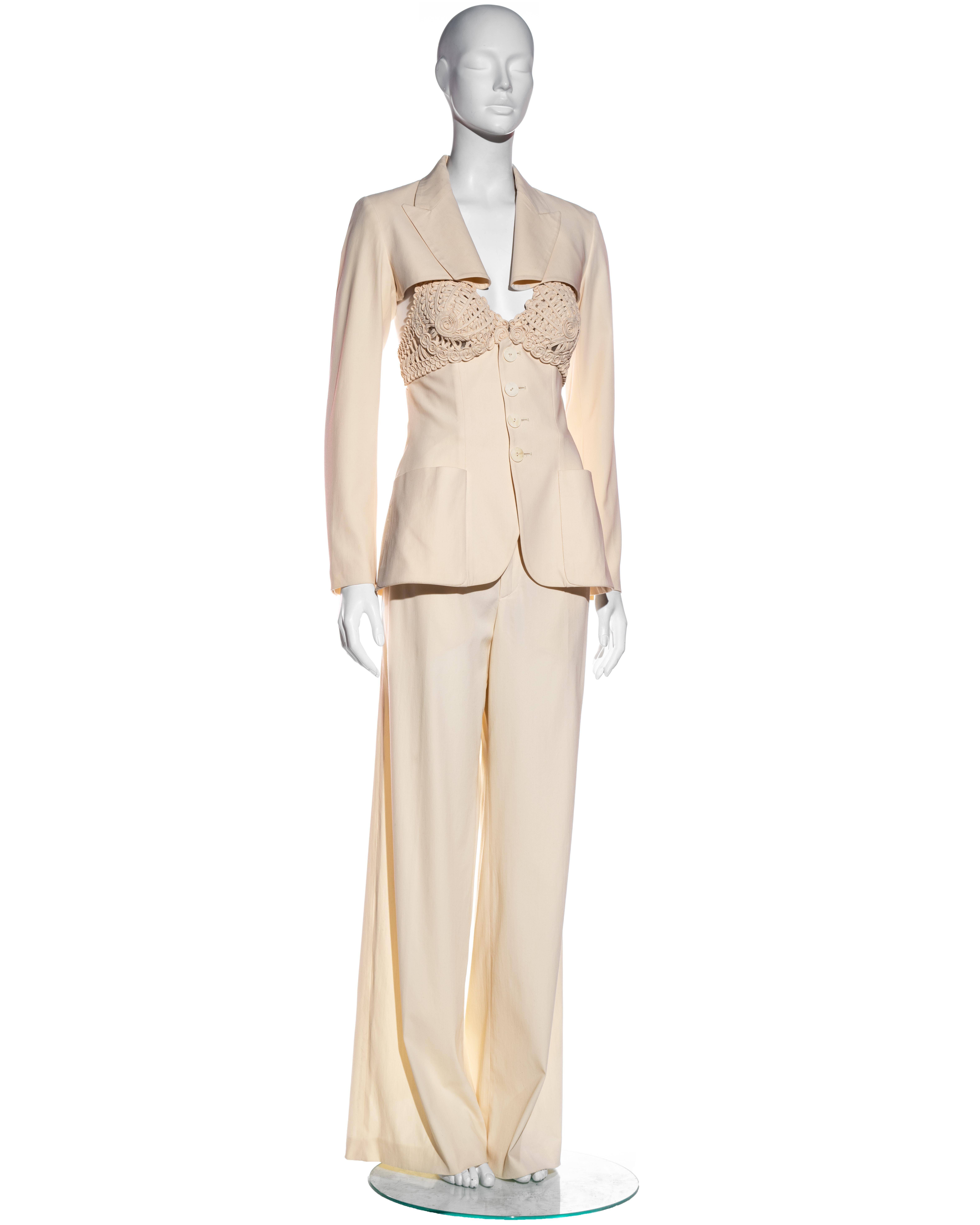 ▪ Jean Paul Gaultier cream wool blend 3-piece pant suit
▪ Macramé bra top with suit-style boned bodice 
▪ Spencer jacket with extended lapel
▪ Wide-leg trousers 
▪ IT 44 - FR 40 - UK 12 
▪ Spring-Summer 2007