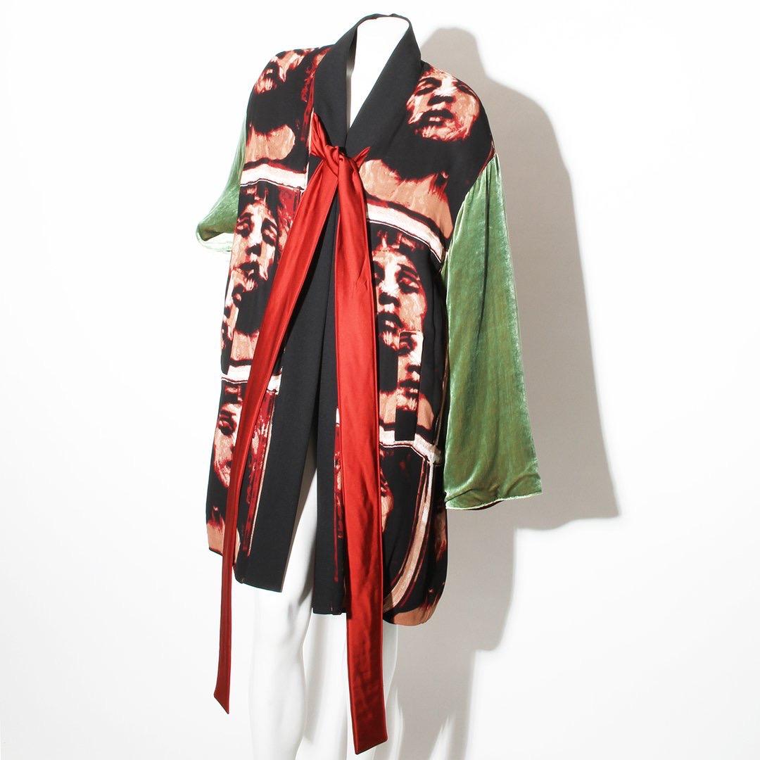 Product Details:
Crisscross puffer robe by Jean Paul Gaultier 
Multi color panels 
Green velvet sleeves 
Distorted face print 
Black trim 
Silk tie front closure 
4 pockets 
Reversible style 
Red satin interior that can be worn as the outer shell