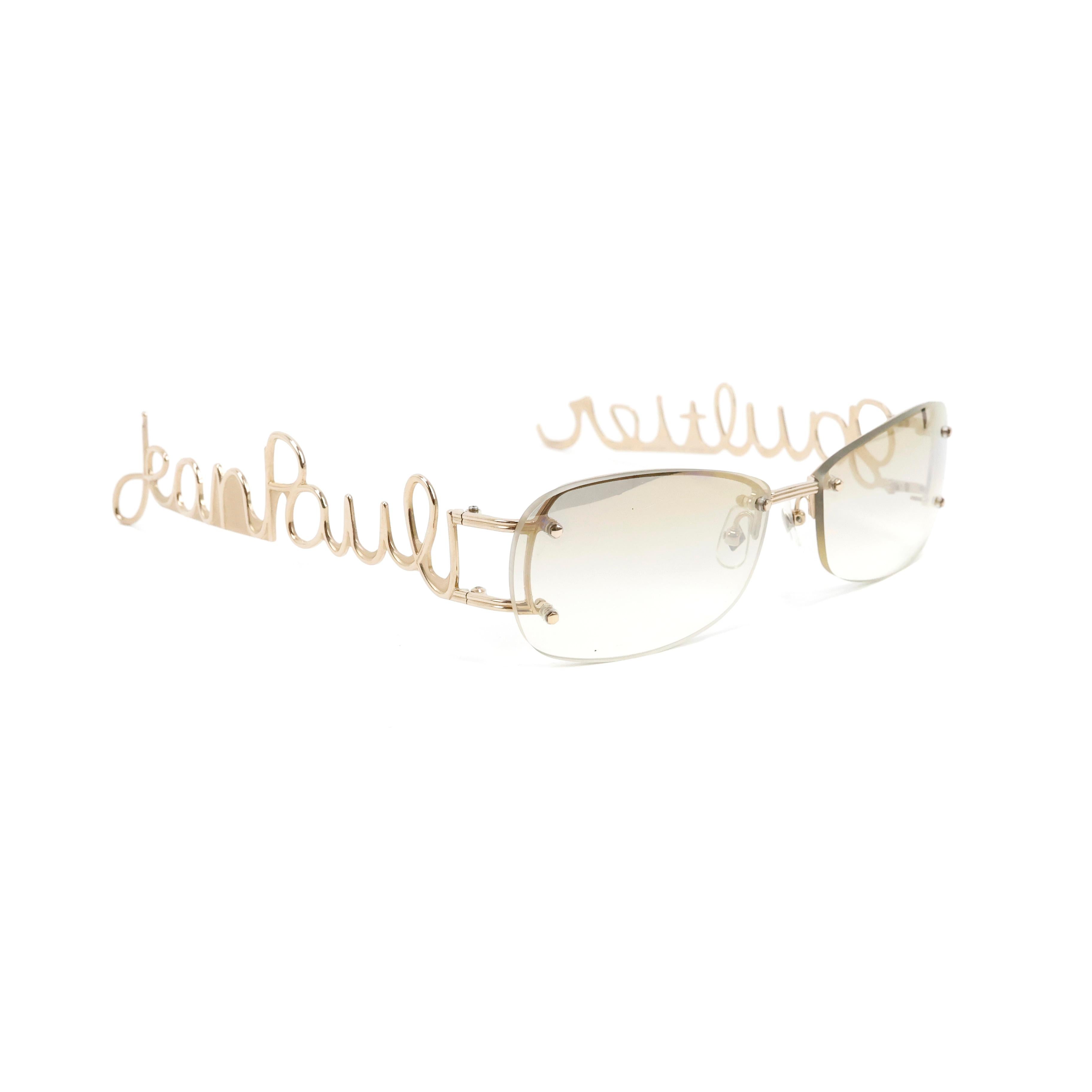 Rare Jean Paul Gaultier cursive logo sunglasses in gold.


Condition:
Really good.


Packing/accessories:
Case.
