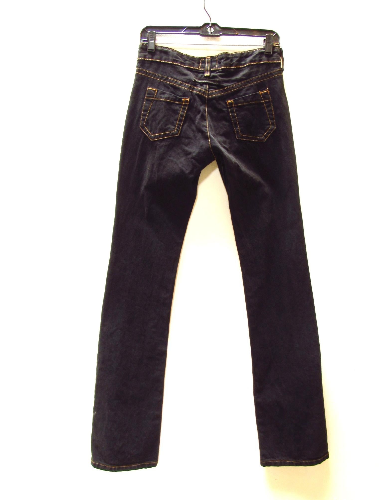 Vintage dark wash denim from Jean Paul Gaultier with distinctive orange contrast stitching. Inside waist is lined with cotton emblazoned with cheeky skull art. 