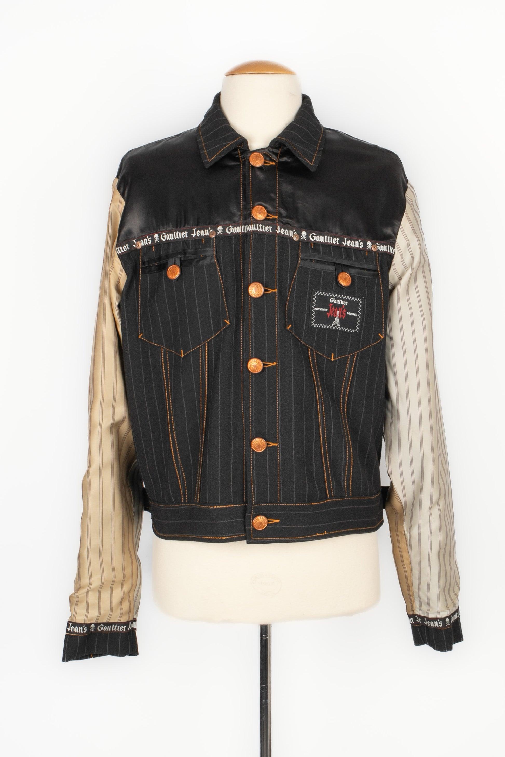 Jean-Paul Gaultier - Striped black denim reversible jacket with coppery metal buttons. Composition and size labels missing, it fits a 42FR. To be mentioned, some stains on the satin side of the sleeves.

Additional information:
Condition: Good