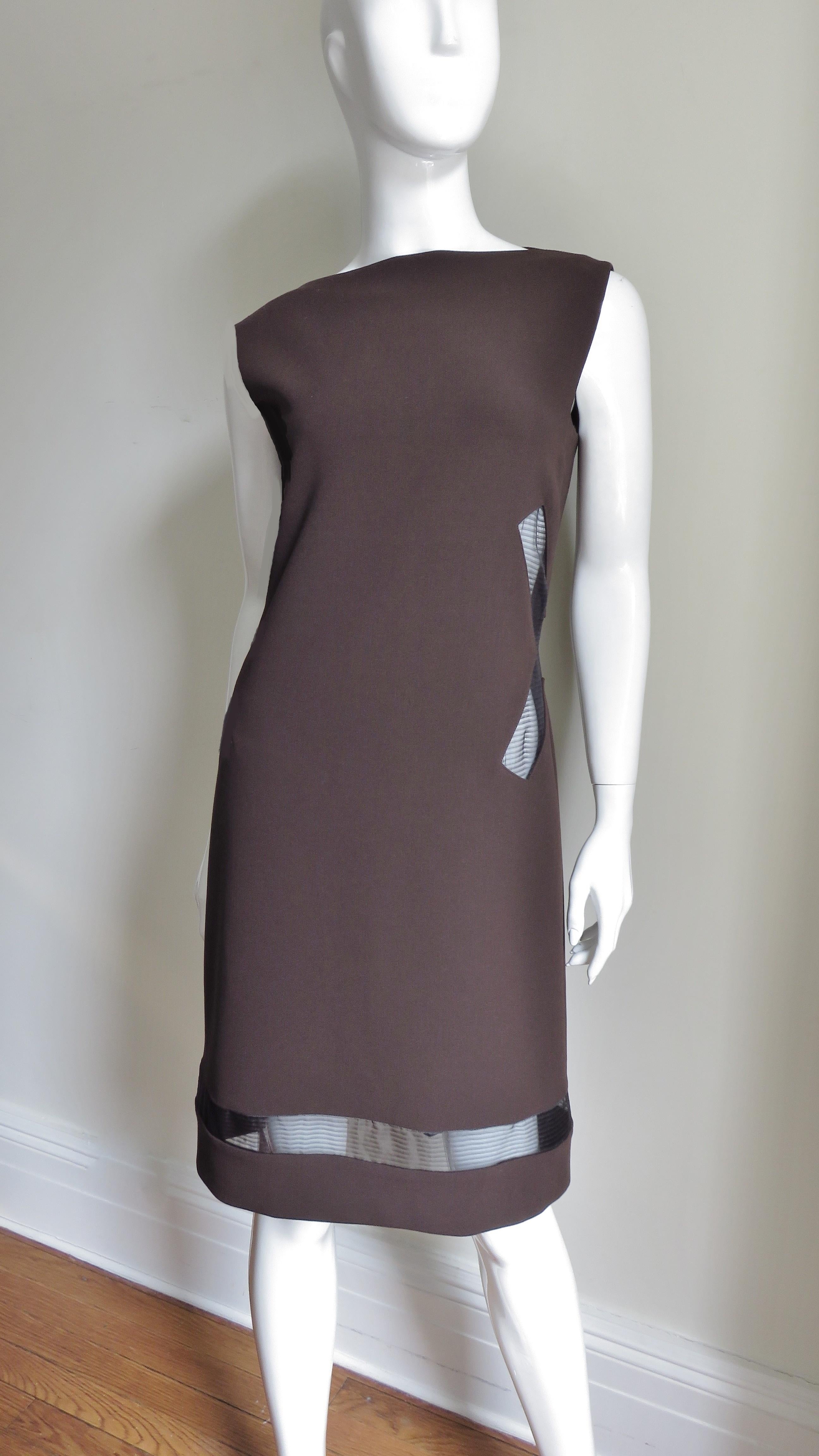 A fabulous rich brown silk jersey dress from Jean Paul Gaultier.  It is sleeveless with a bateau neckline and X shaped mesh covered cut outs at each side of the waist plus a strip around the circumference of the dress just above the hem. The dress