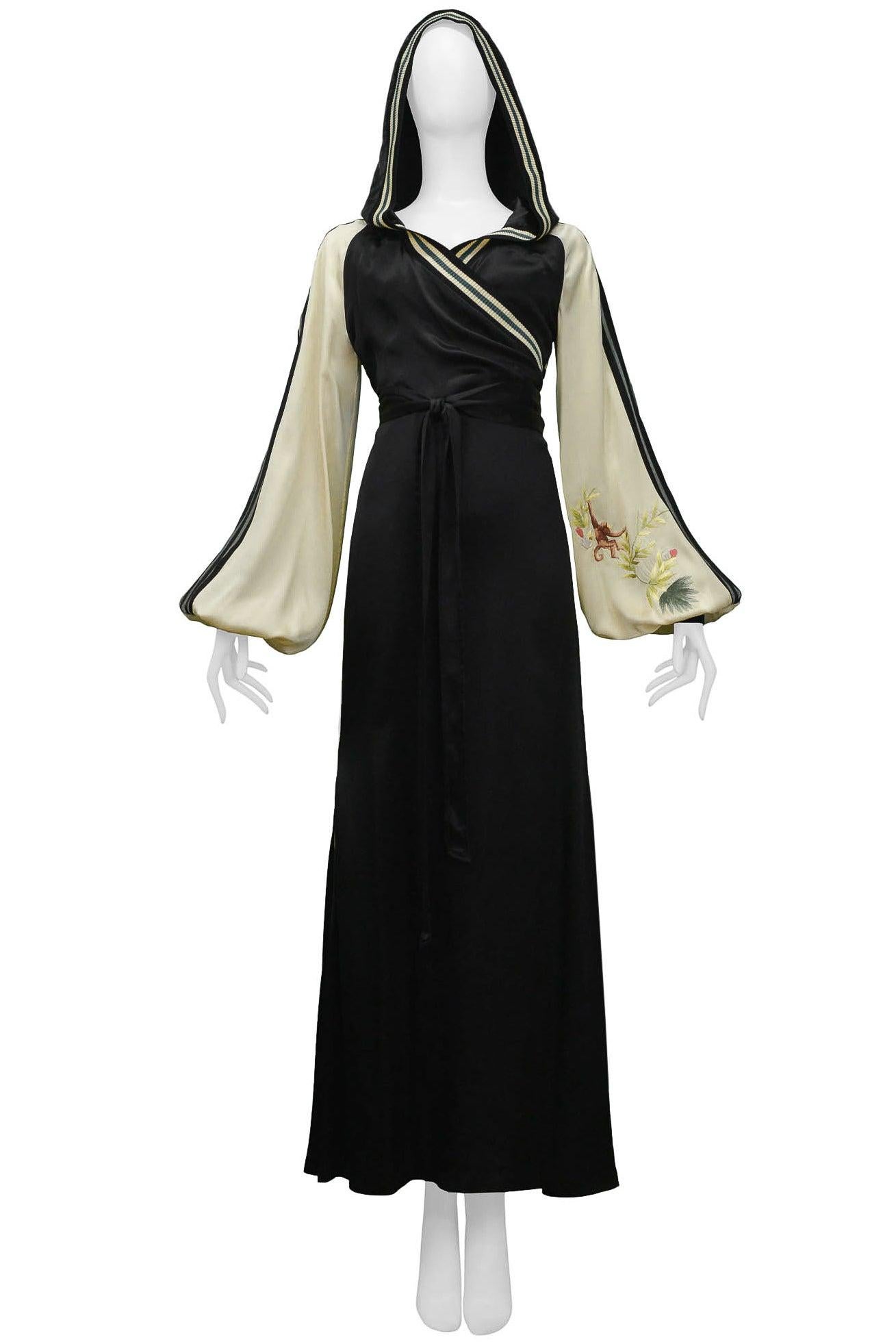 Resurrection Vintage is excited to offer a vintage Jean Paul Gaultier black and cream satin ensemble that includes a wrap front jacket and long satin dress.  The ensemble features embroidery detailing on the front sleeves and back of the jacket,