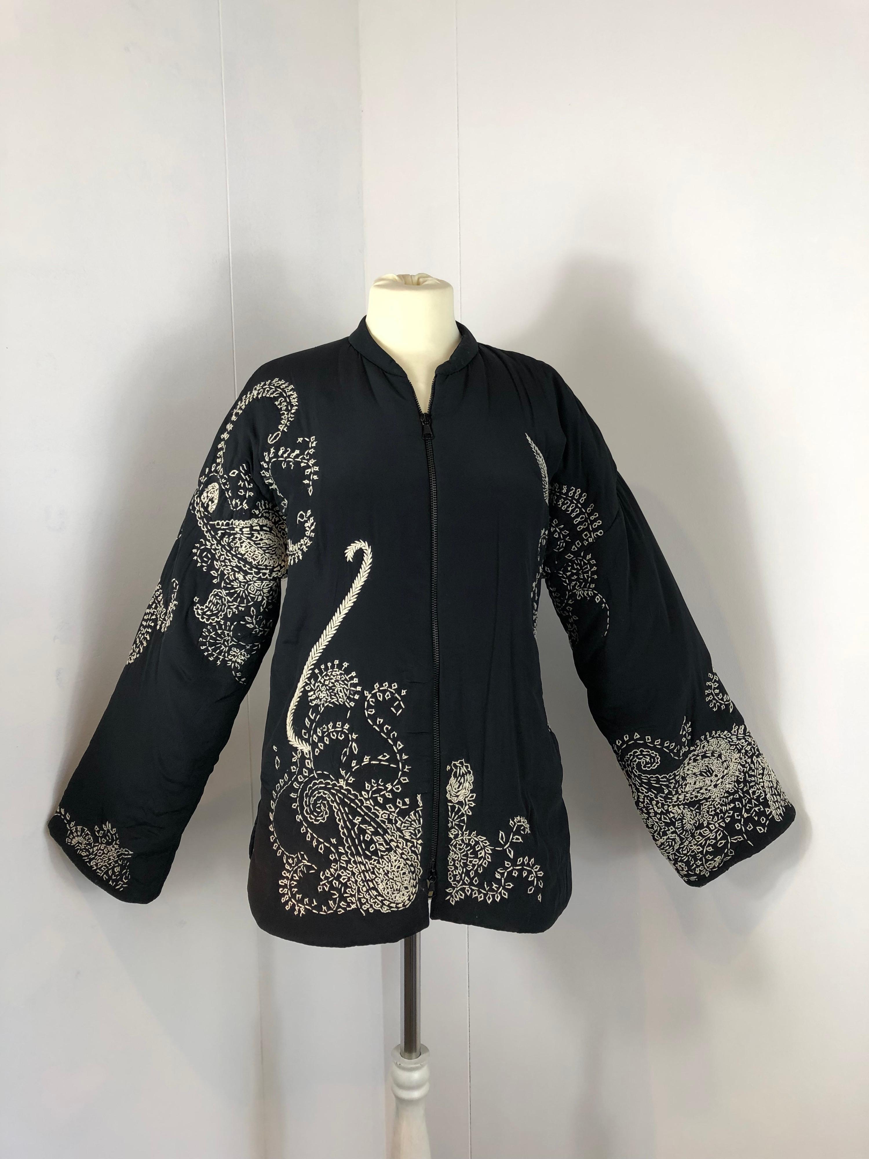 Jean Paul Gaultier , Femme, jacket. 
Main Fabric is a mix between acetate and silk. Very soft at the touch. Second fabric is cotton.
Lining is polyester. 
Featuring 2 frontal pockets, zip closure and amazing white embroidery. 
Size 40