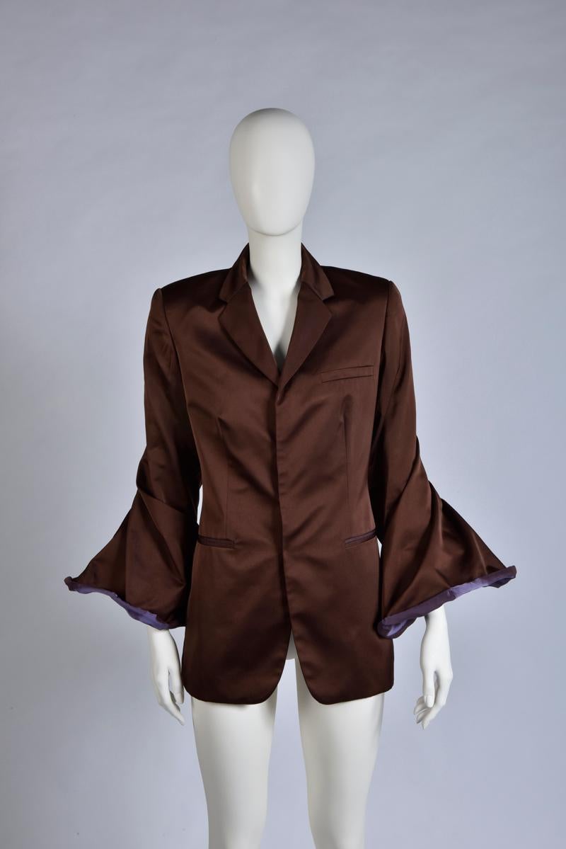With its two tones (eggplant/dark purple) colors versatile bell sleeves, this vintage Jean Paul Gaultier evening blazer will really make an impact. Tailored from lustrous shifting satin, the jacket has a slightly loose fit. Fully lined for an easy
