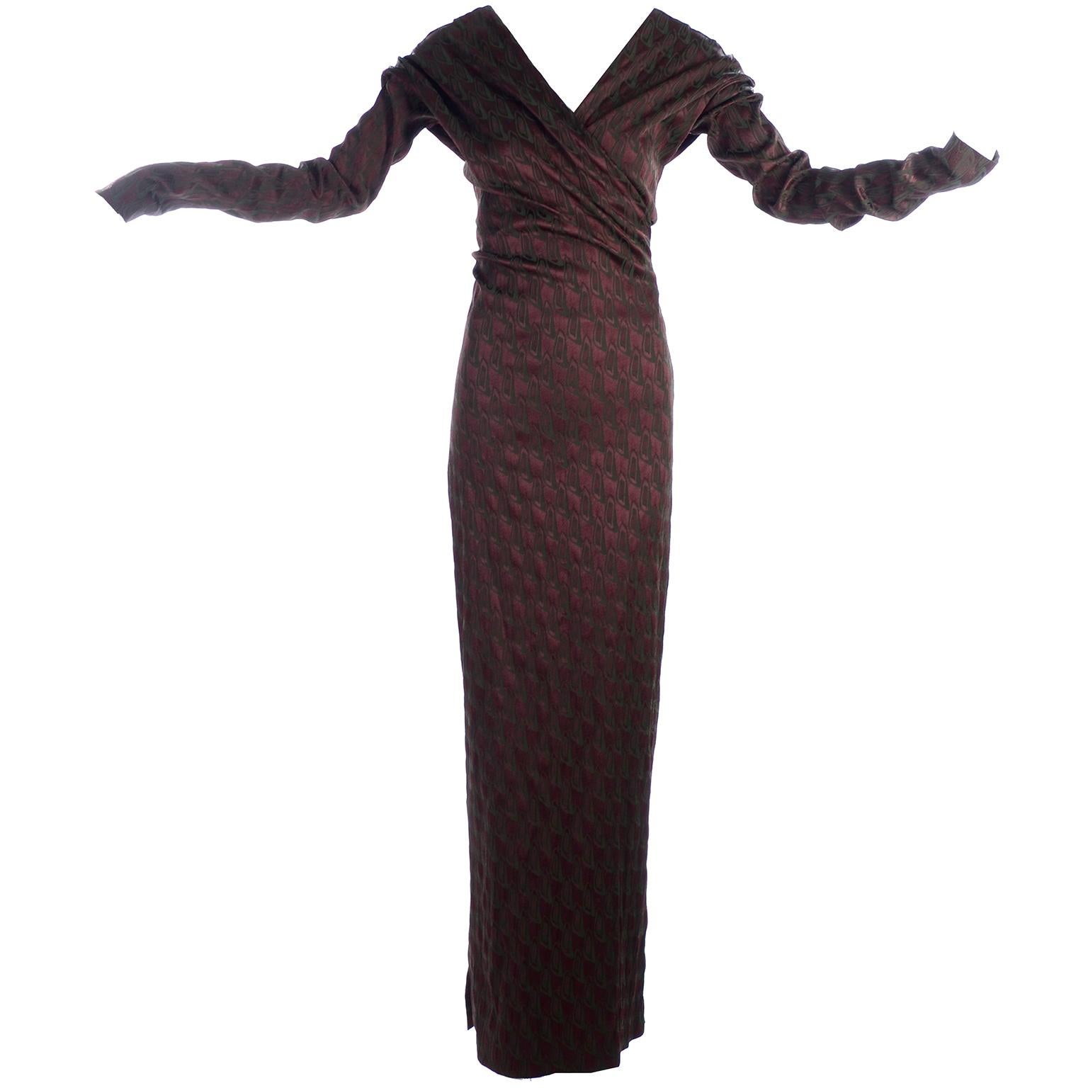 This is a stunning Jean Paul Gaultier full length dress with his iconic long exaggerated sleeves.  The dress has a crossover bodice  and is in a rayon blend deep burgundy and dark green abstract print.  The dress was purchased in the early 2000's