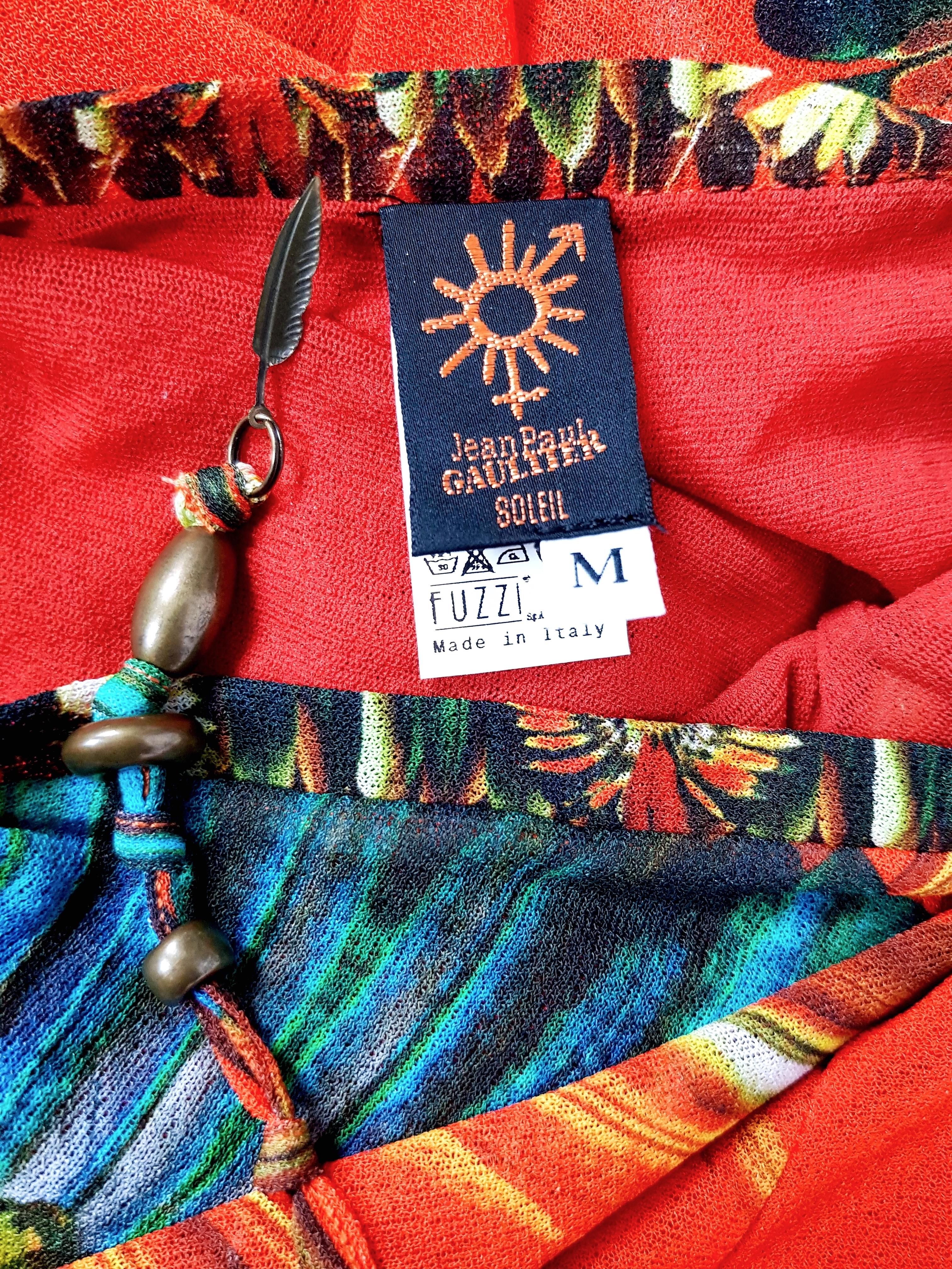 Wonderful JEAN PAUL GAULTIER vintage multicolored feather/exotic print maxi dress featuring a red fabric panel across the chest (made with generous fabric, very wide).
Uber flattering, lightweight, stretchy mesh fabric and self tie halter neckline